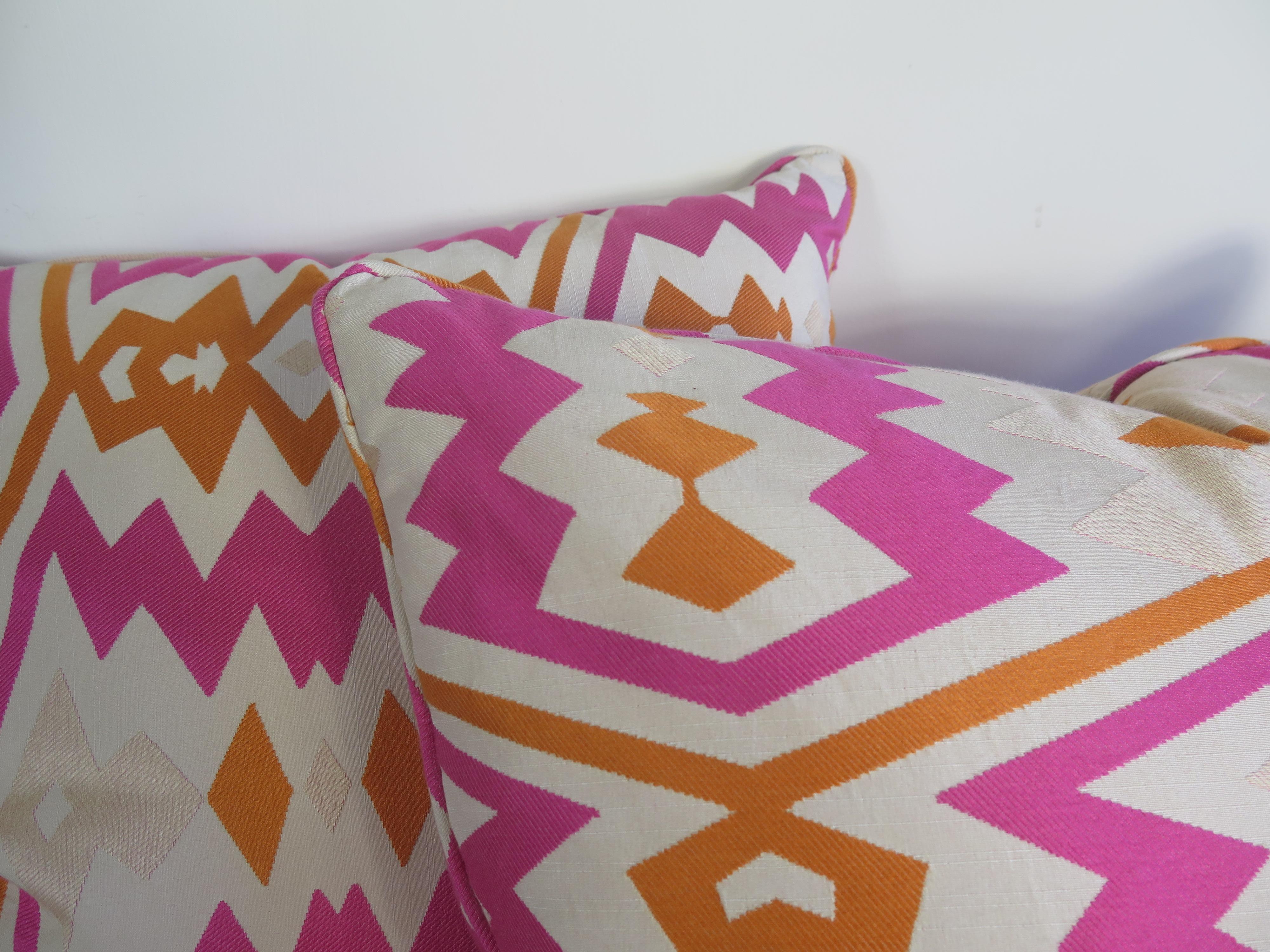 Pair of pink and orange Geometric down pillows.