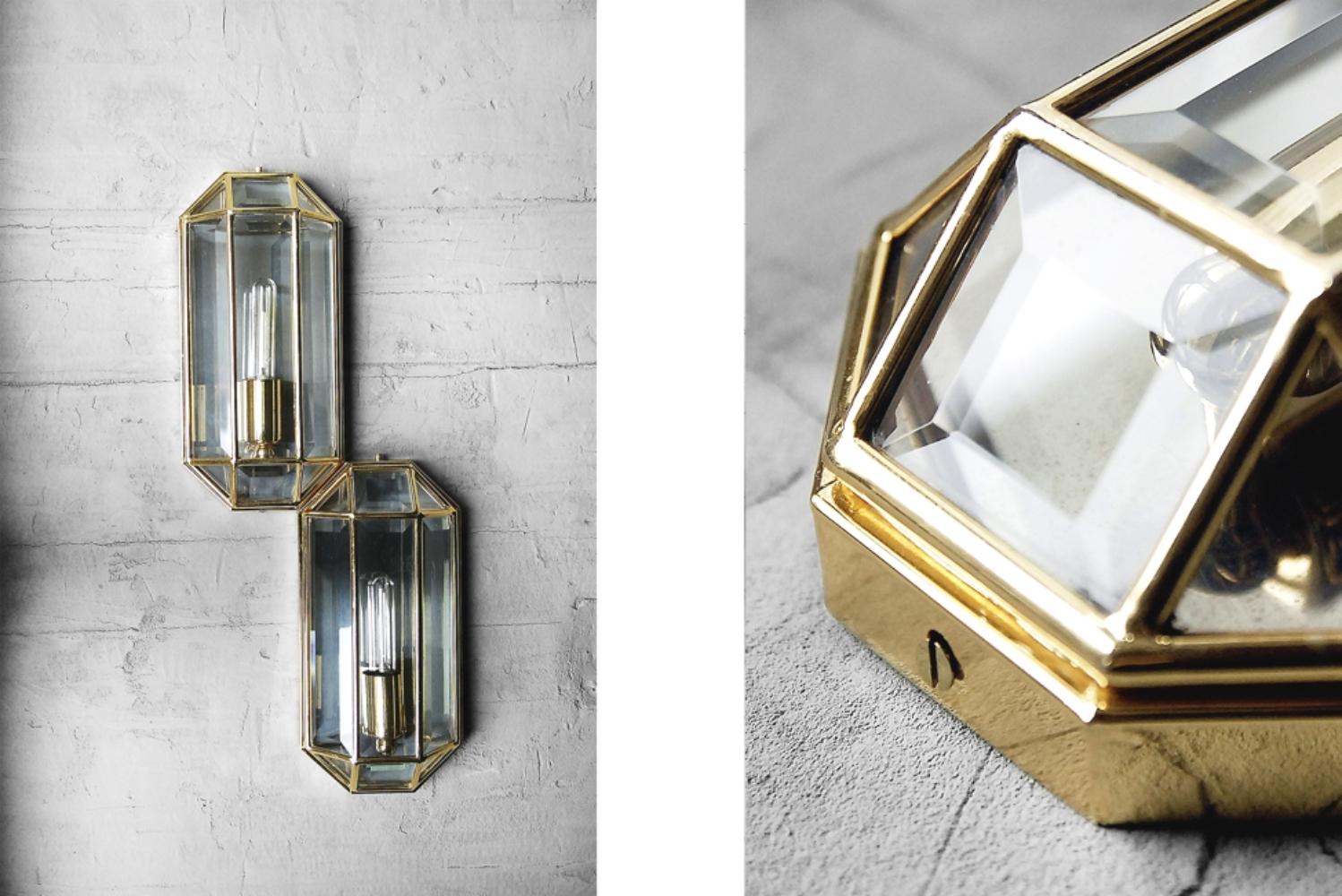 This set of two geometric wall lamps was manufactured in Italy during the 1970s. It has a three-dimensional form. The tiles are made from milled glass and the frame is made from brass. This set is in original vintage condition and has a patine and