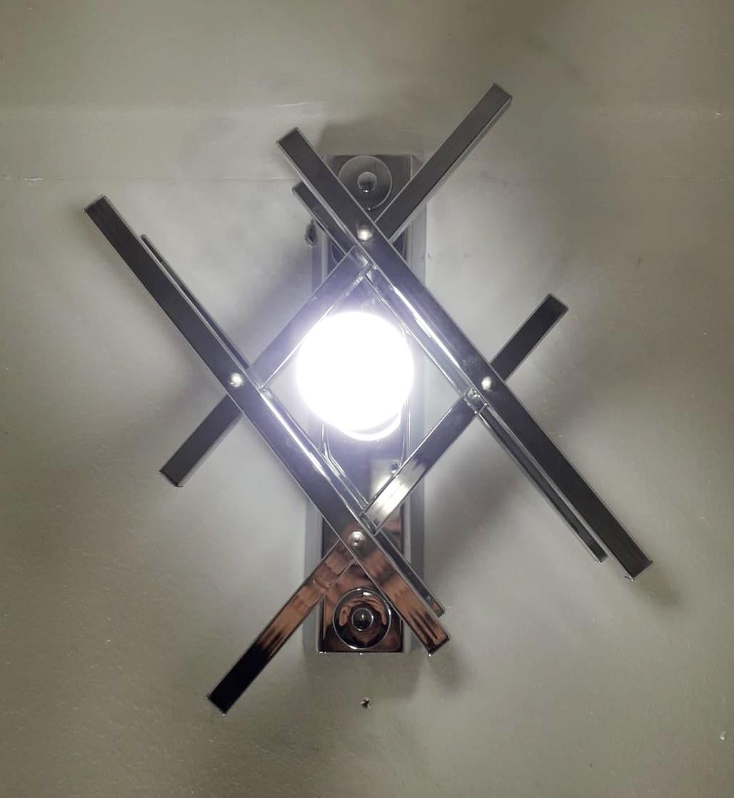 Excellent vintage condition midcentury Italian wall lights formed with geometric chrome arms that enclose a single light bulb at the center, designed by Gaetano Sciolari / Made in Italy circa 1970s
1-light / E26 or E27 type / max 60W
Measures: