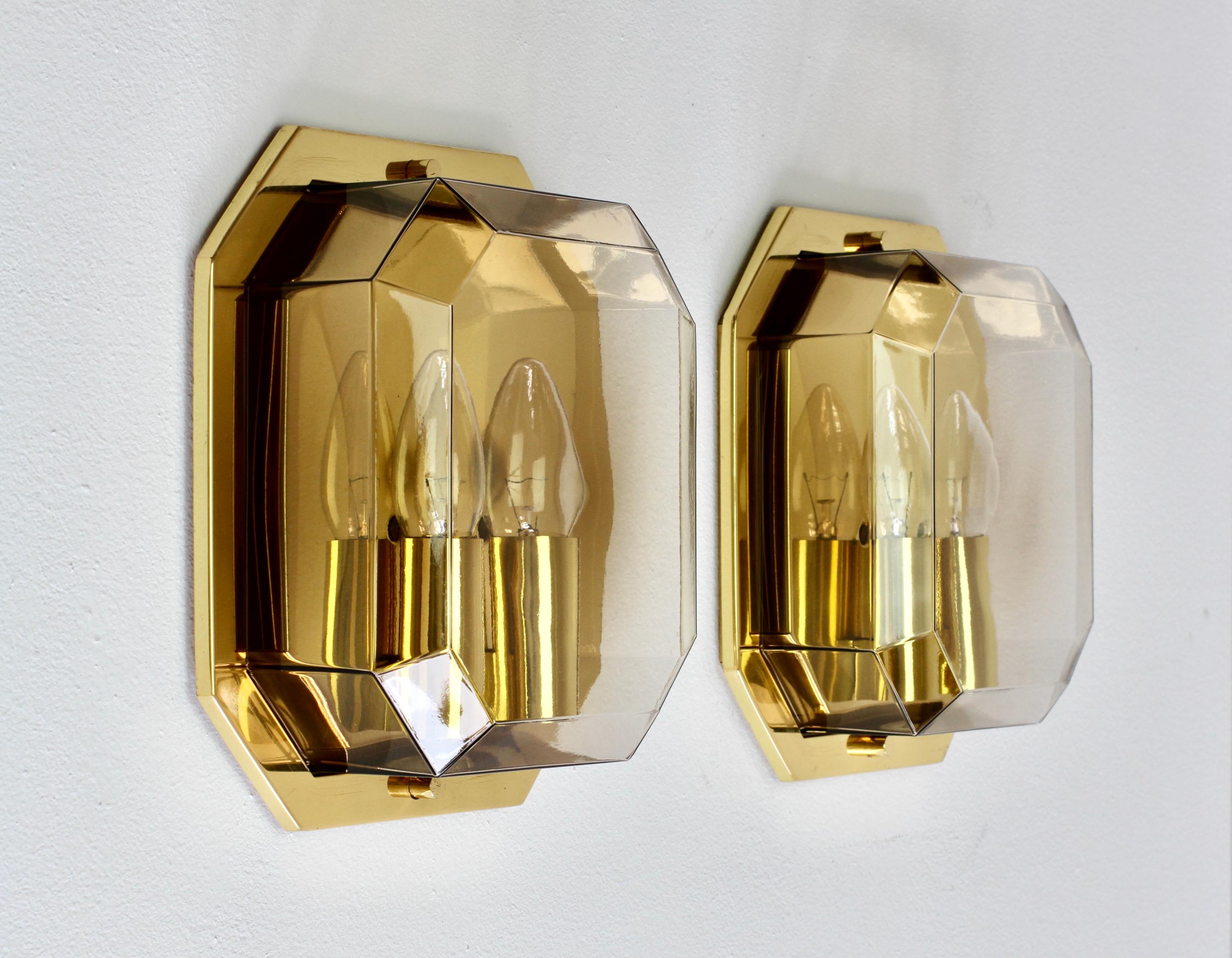 Pair of stunning and elegant vintage mid-century double socketed flush mount wall lights, lamps or sconces by iconic German lighting manufacturer Glashütte Limburg, circa 1975-1985. Featuring a geometric shaped mouth blown smoked or tinted glass