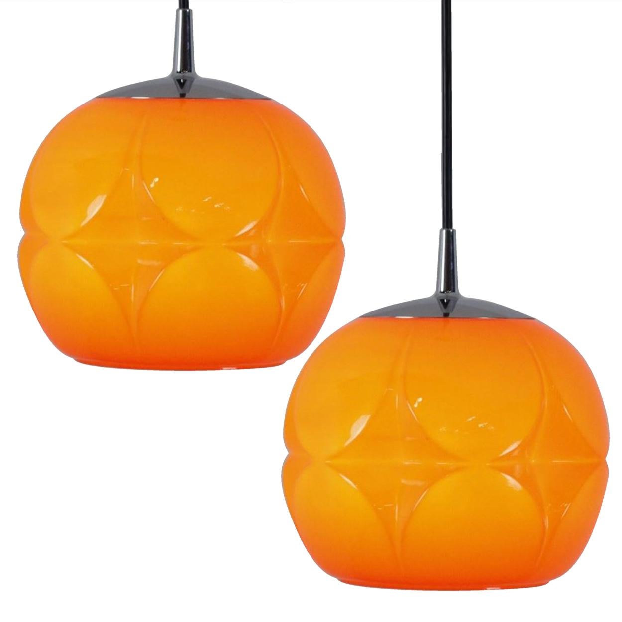 There’s something about orange that screams this particular era. And this 1970s pair of Peil & Putzler ceiling pendant lamps is very orange! Image 2 is the lamp with the light on.

The lampshade is made of a ‘cast opaque orange glass’ with an