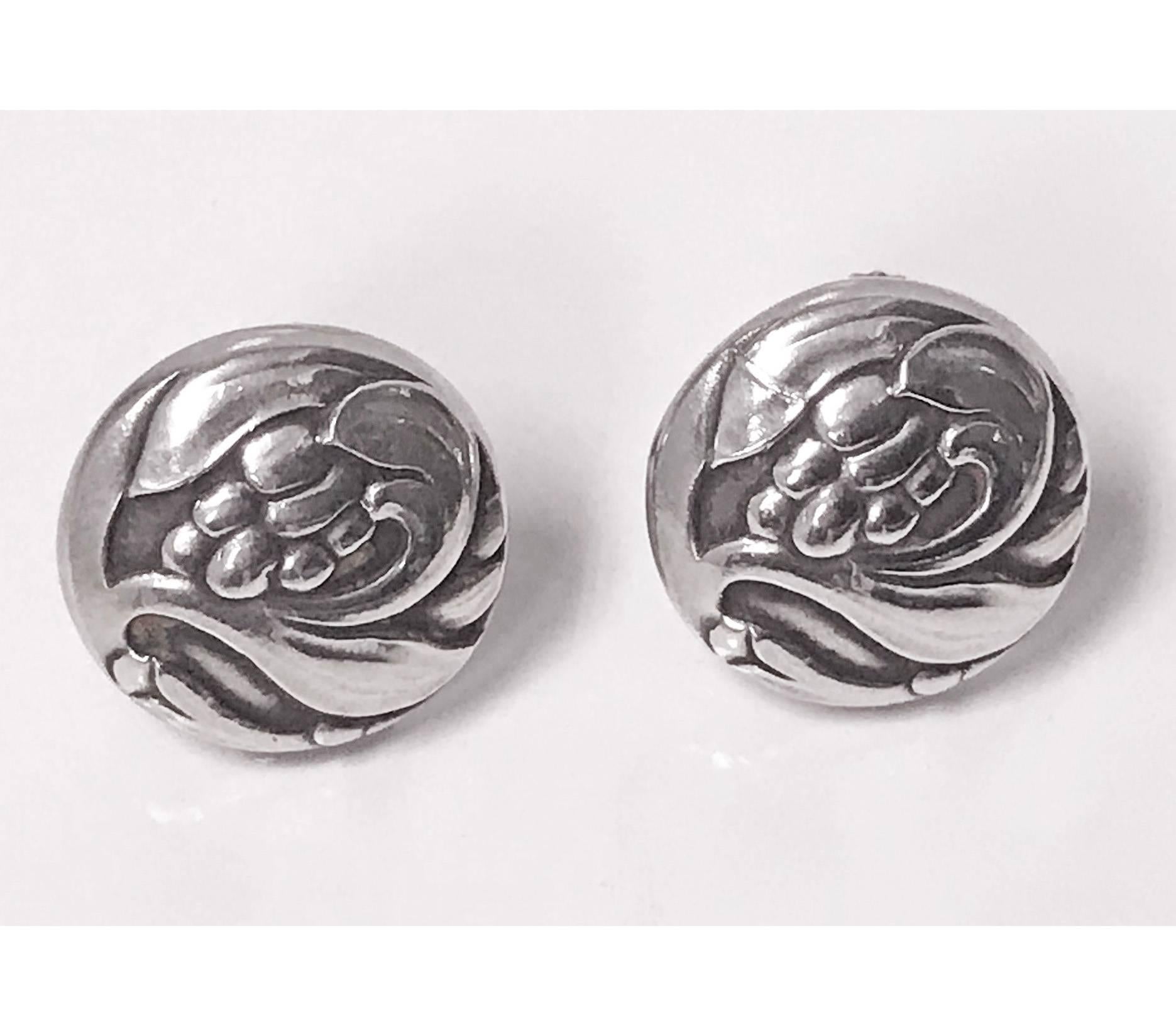 Pair of Georg Jensen Sterling Earrings, 1933-44 mark. The screw back earrings of slightly concave swirl foliate and berry design. Fronts measure approximately 17.60 mm. Full Georg Jensen marks to reverse with GJ mark for 1933-1944. Original screw