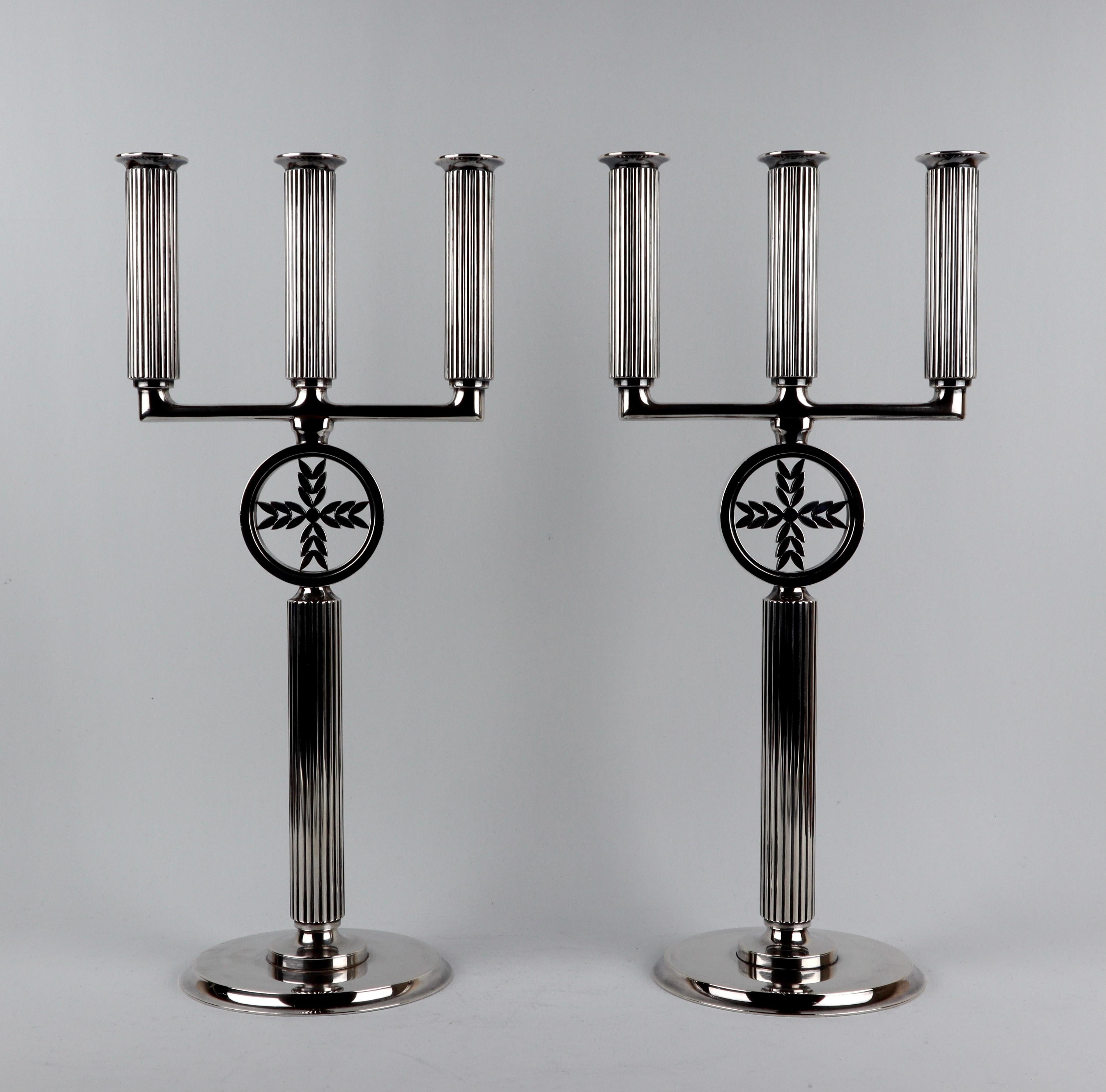 This magnificent pair of sterling silver Georg Jensen candelabras with hand chased stems, design 855C, were designed by Sigvard Bernadotte.

Hallmarked for Denmark 1945
Makers Mark Georg Jensen 
Designer Sigvard Bernadotte 

Measures: height