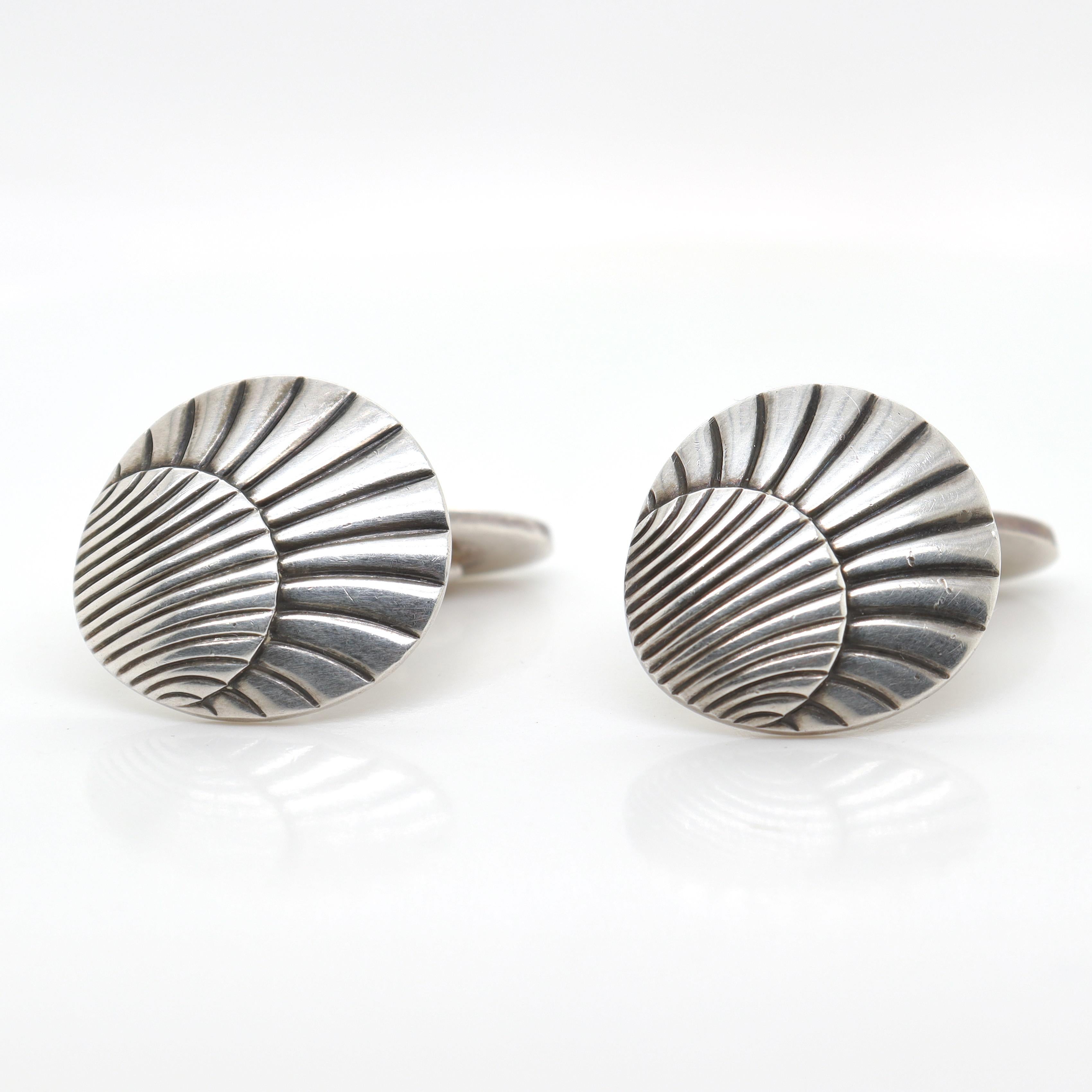 A fine pair of Georg Jensen sterling silver cufflinks

Model no. 99.

Simply a wonderful pair of cufflinks from one of Denmark's premier silversmiths!

Date:
20th Century, post-1945

Overall Condition:
They are in overall good, as-pictured, used