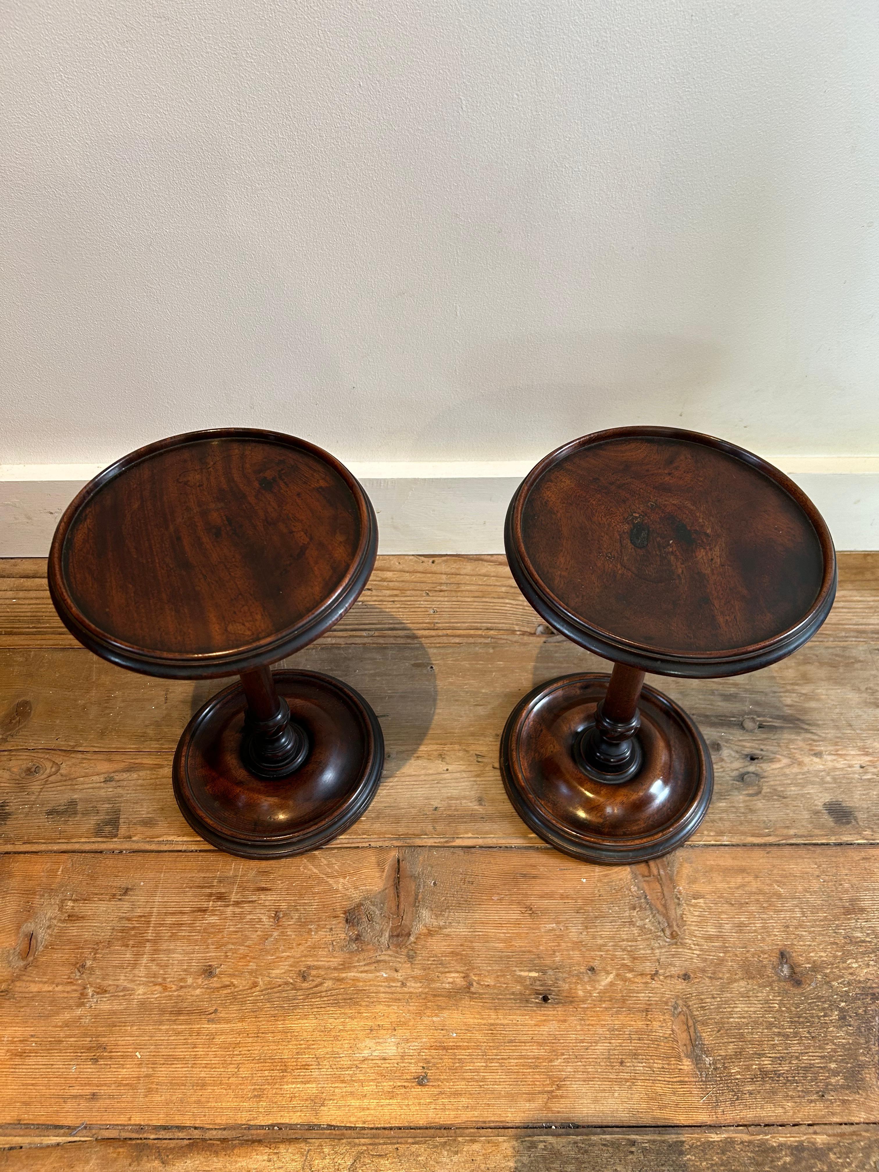 Pair of English mahogany candle stands, circa 1760 with circular lipped top sitting on a rhythm fluted turned baluster column, ending on a turned moulded lead waited base. These sweet candle stands have their original slightly worn baize, they are