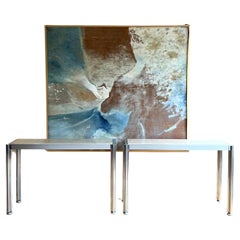 Pair of George Cianciamino brushed aluminium and travertine console tables