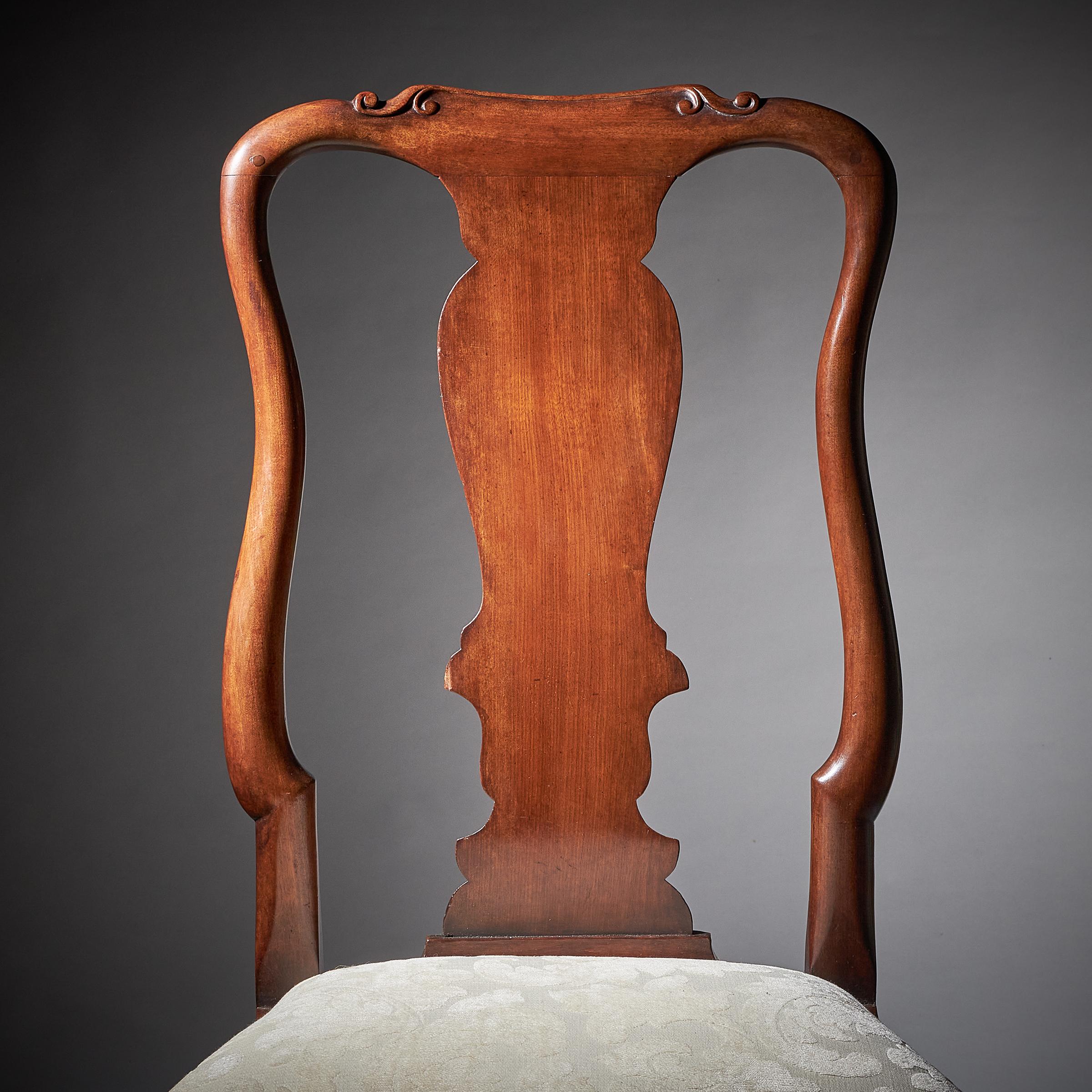 A superb pair of early 18th-century carved George I mahogany chairs, circa 1720.

Each chair is of rich colour, patination and carved throughout.

The shaped crest rails have two scrolls on each end joining to cascading s-scroll styles and