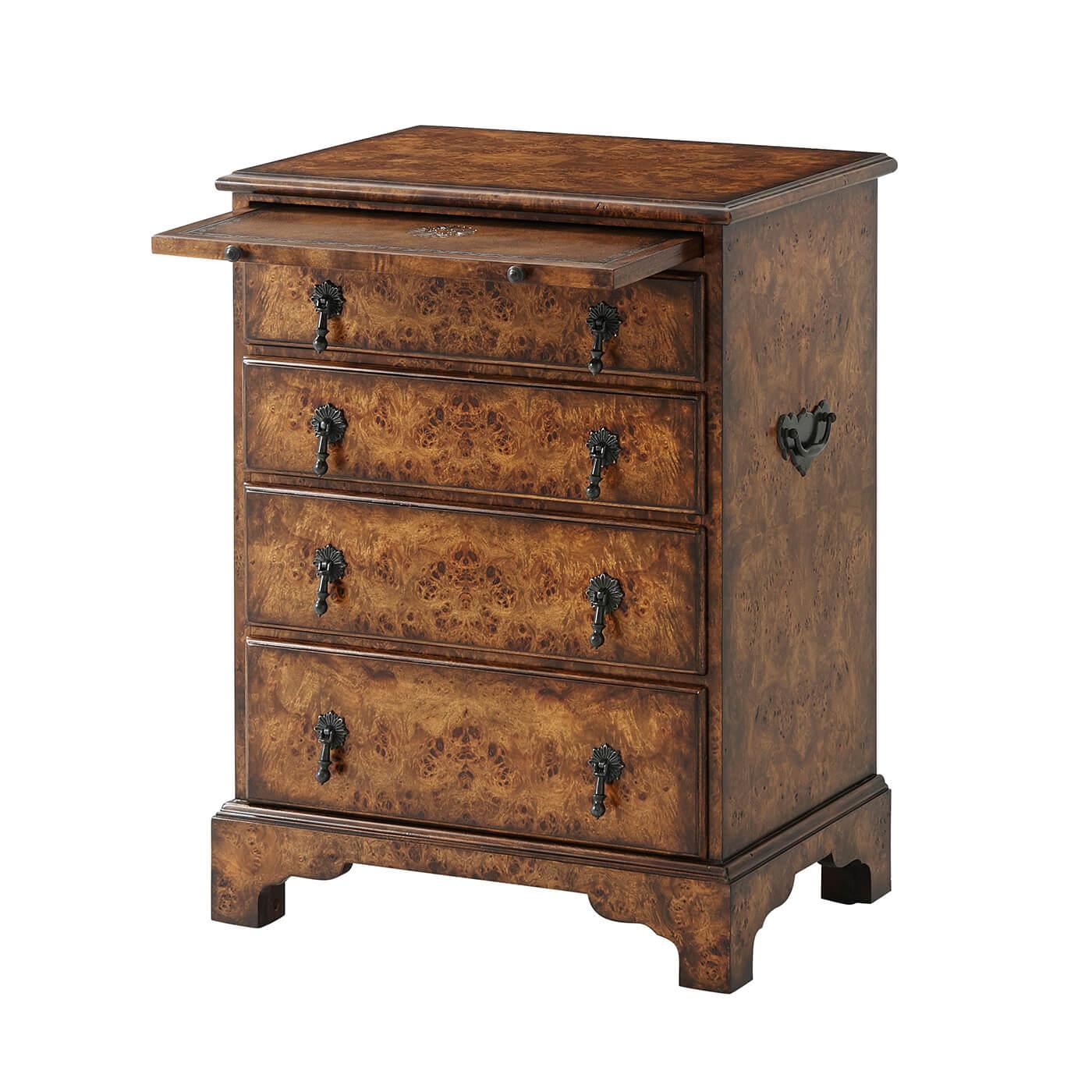 An English Georgian style poplar burl bedside chest, the rectangular molded edge top with a leather inset slide and four graduated drawers, on bracket feet. 

Dimensions: 21