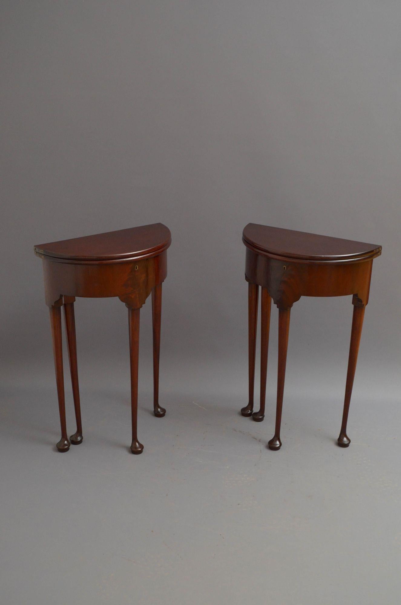 Sn5406 Pair of fine quality George II solid mahogany, demi lune occasional tables of narrow proportions, each having figured mahogany fold over top enclosing small storage space, flamed mahogany frieze and four slender legs terminating in pad feet.