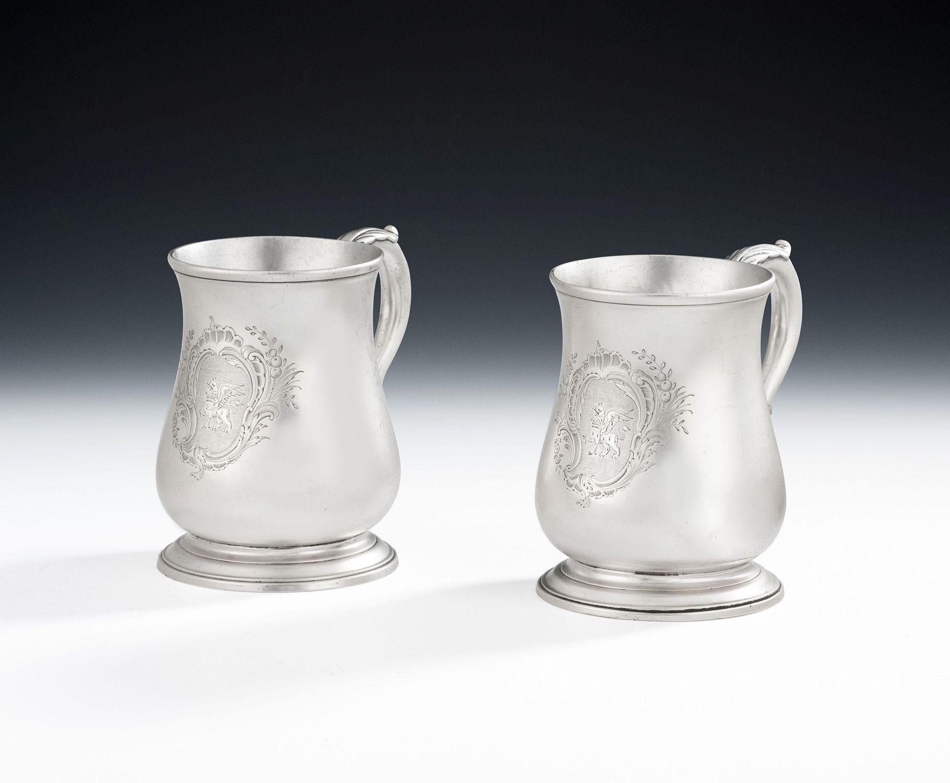 A Very Fine Pair of George II Half Pint Mugs Made in London in 1754 by Thomas Whipham.

The Mugs stand on a cast and applied spreading foot and display a baluster shaped body with slightly flared rim. The scroll handle is decoarted with leaf capping