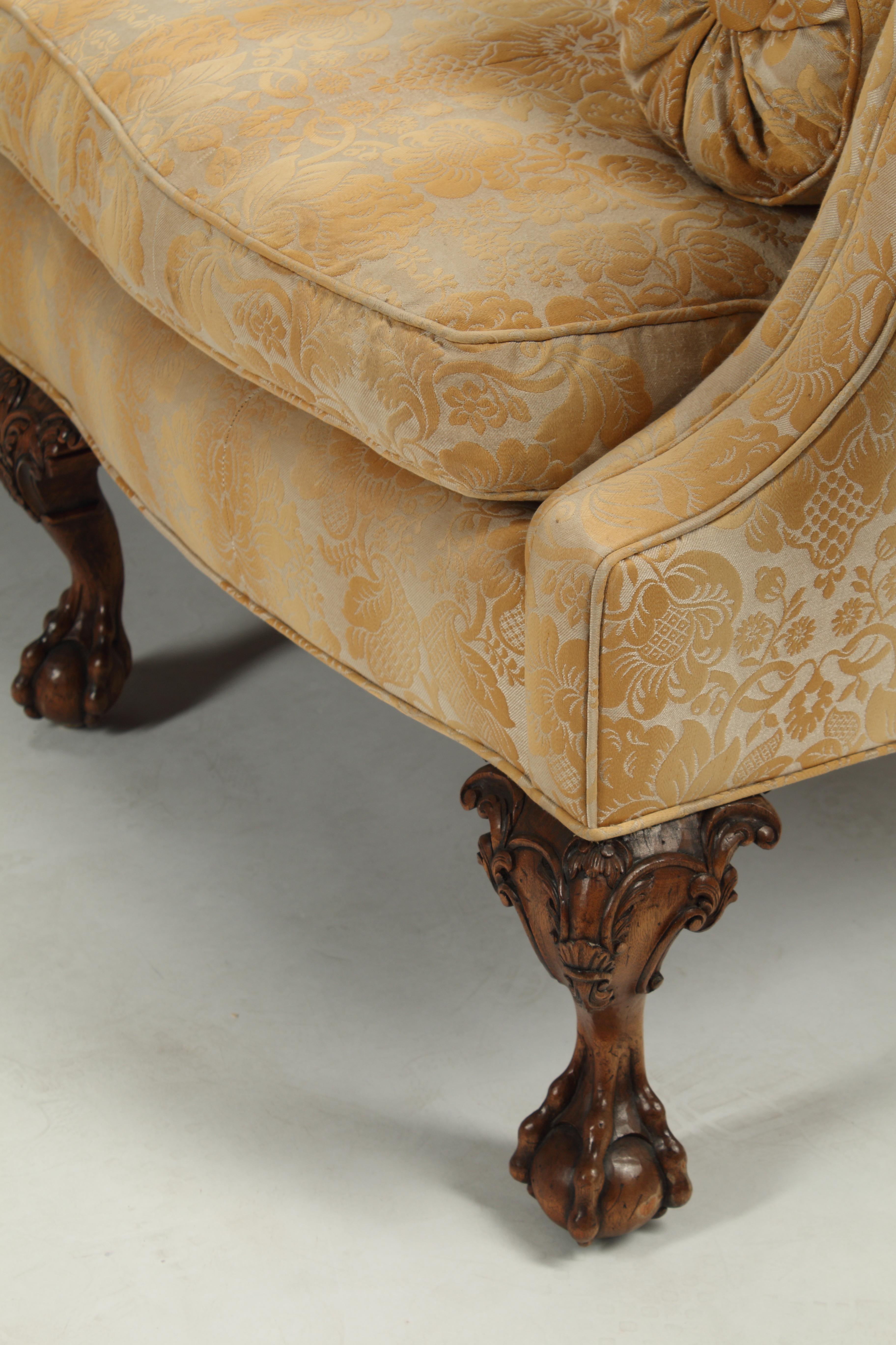 An elegant pair of English George II style camel back sofas with eight finely carved walnut claw and ball feet.
Upholstered with Scalamandré beautiful fabric in fair condition.