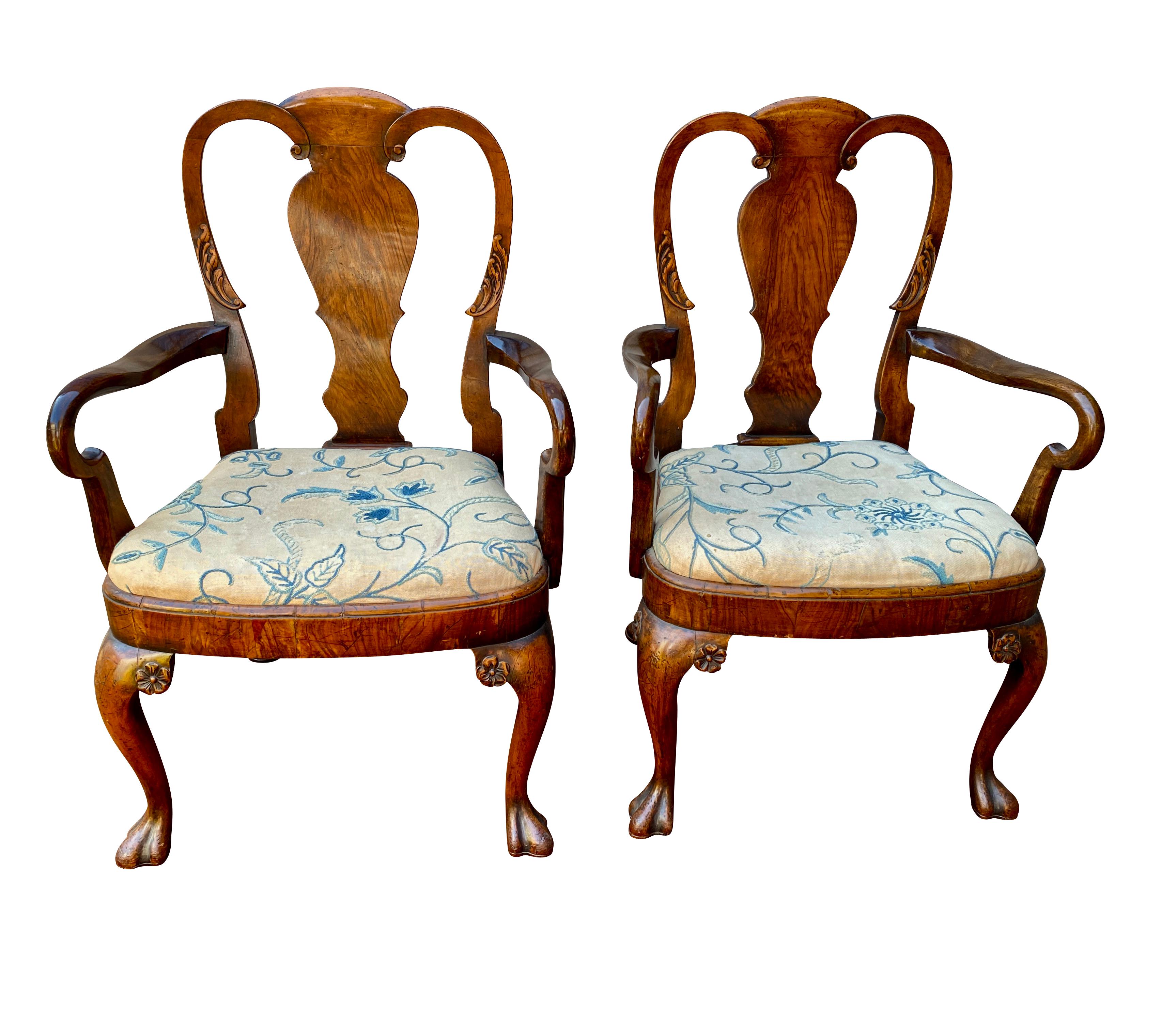 Each with an arched crestrail and vase form splat, crook form arms and bowed seat with drop in upholstered seats raised on cabriole legs with trifid feet.