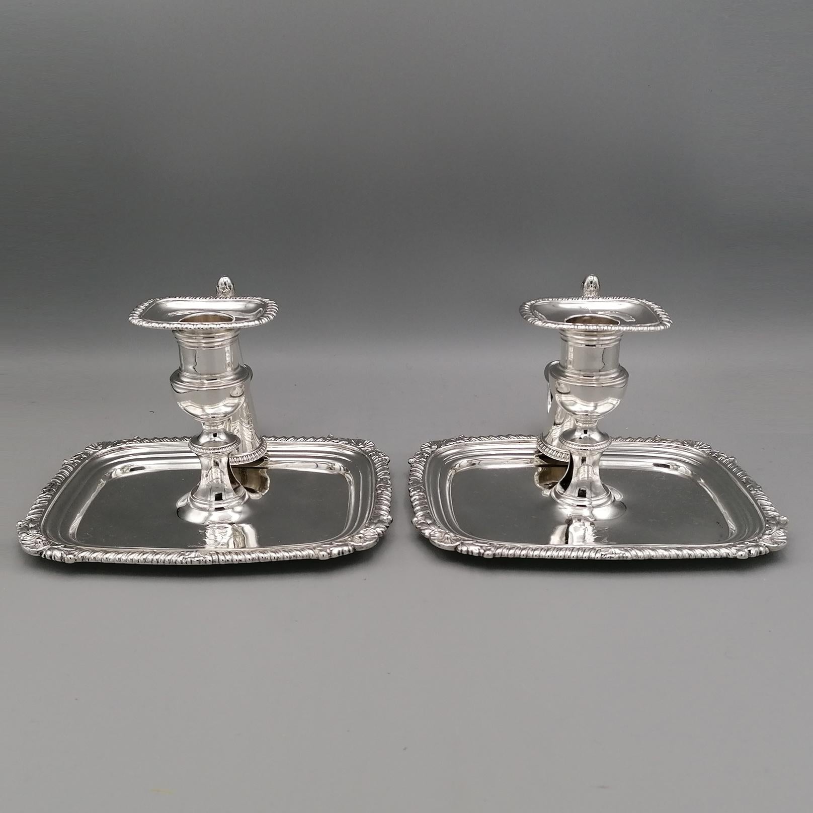 An important full marked Antique Georgian sterling silver pair of oblong chambersticks, having a rectangular body with a gadroon & shell border, a side-handle with original removable snuffer. 
These elegant antique silver chambersticks was made by