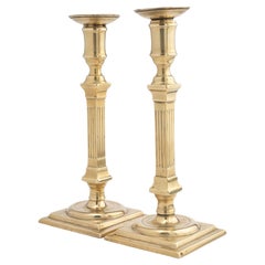 Pair of George III cast brass columnar candlesticks, 1790-1800