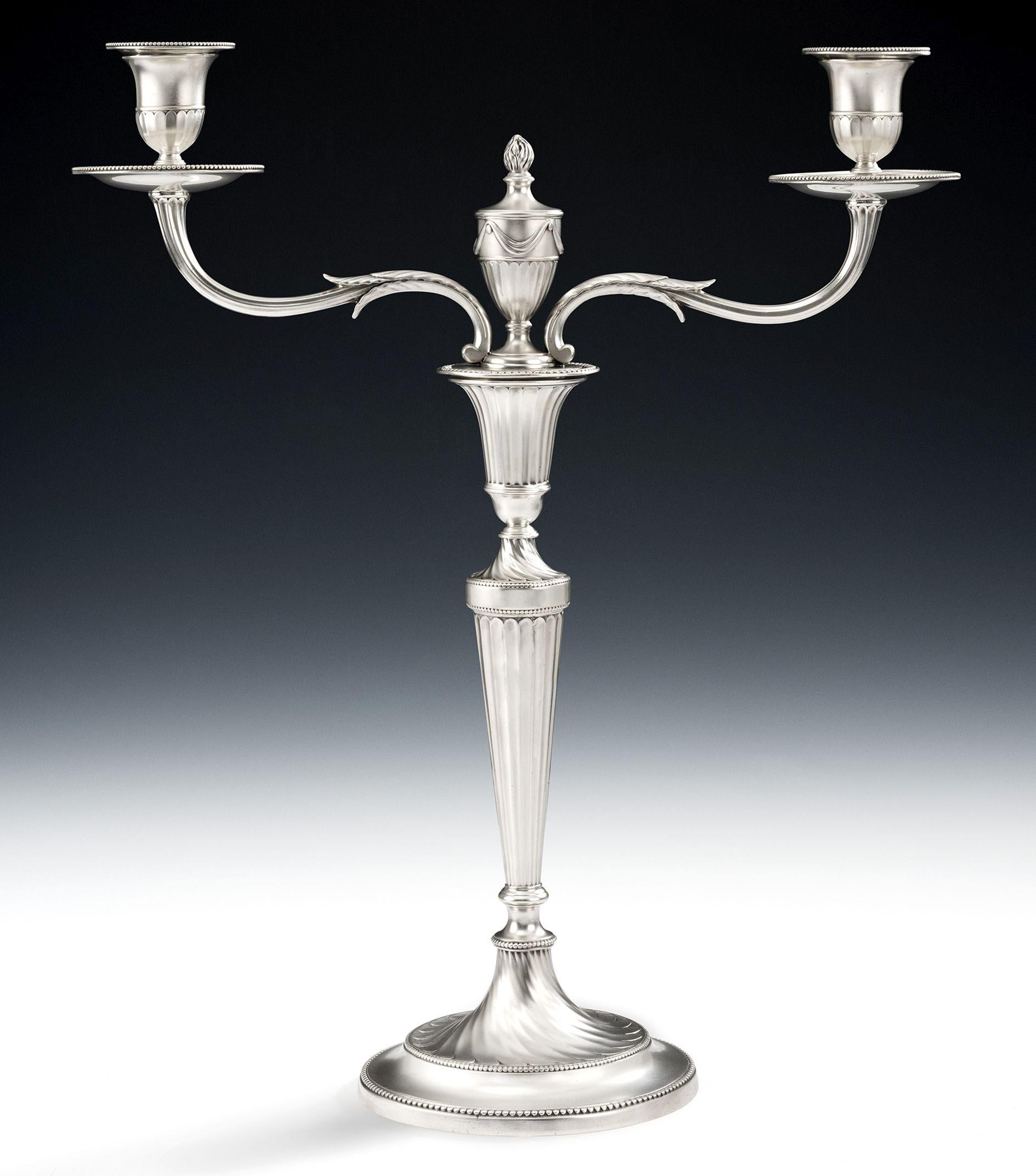 The Spencer Candelabra. An important pair of George III Cast Neo Classical Two Light Candelabra made in London in 1782/83 by John Schofield.

Each piece is cast and stands on a circular foot which is decorated with three bands of beading and