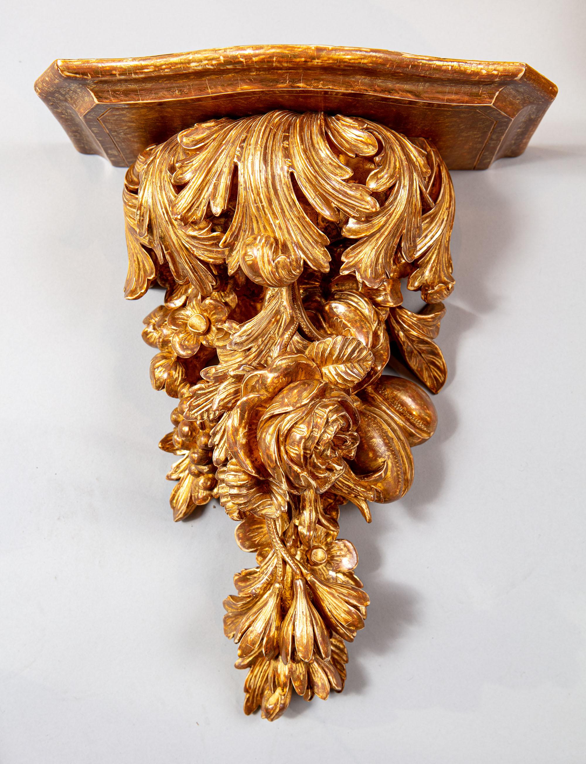 An exceptional pair of mid-18th century carved and water gilt wall brackets profusely carved with acanthus leaves and swags of plump roses, ripe fruits, harebells and flower heads.

England, circa 1760

Measures: Height 14 ins / 35.5cm
Width 11