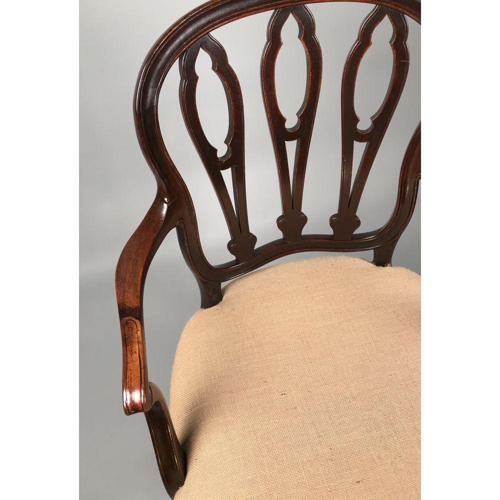 A very close pair of English George III period Hepplewhite mahogany armchairs.

In the French taste, with Gothic-shaped pierced back splats and moulded frames throughout. 
Raised on elegant cabriole supports terminating with a ''French'' scroll