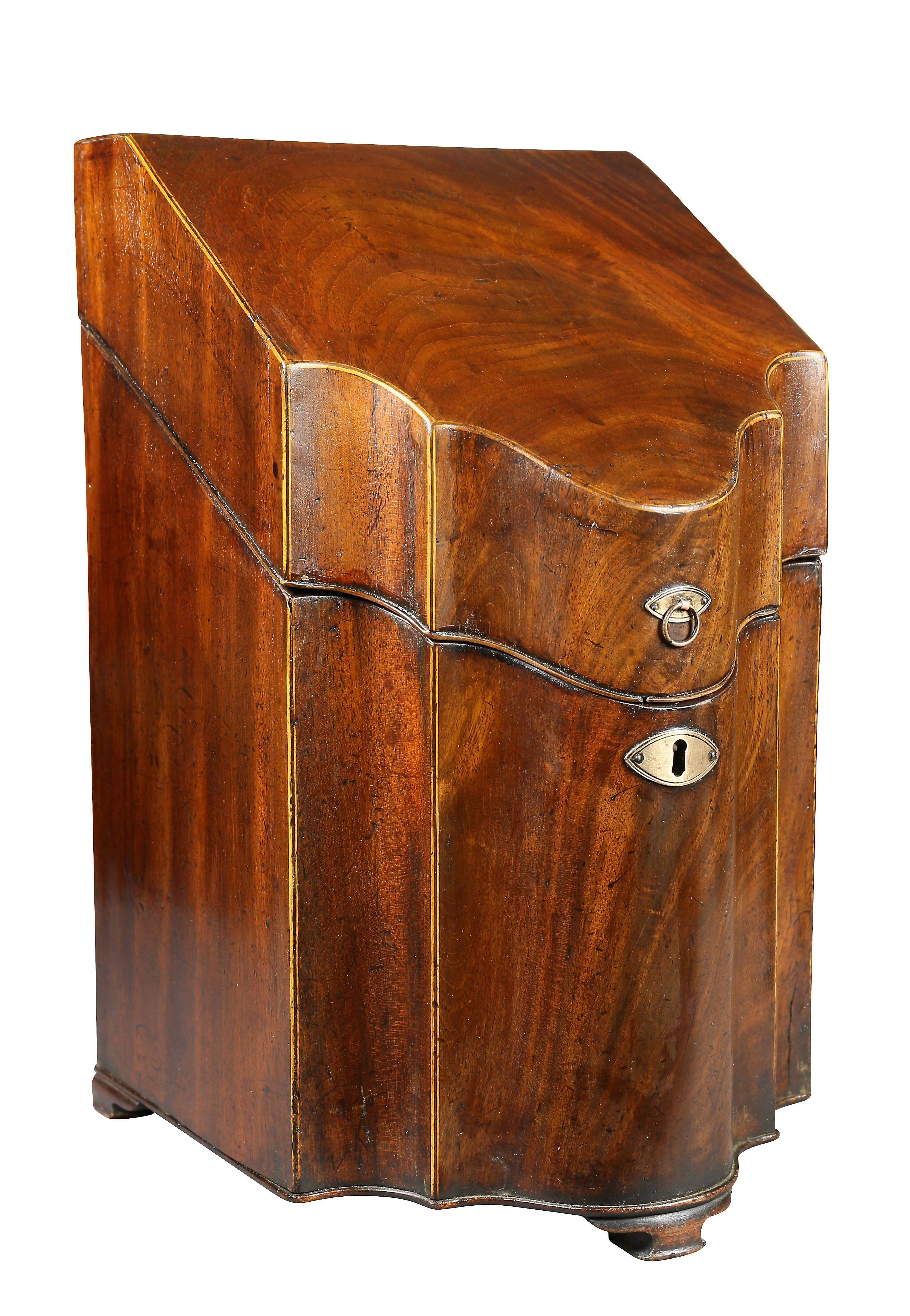 Each with hinged slant lids opening to a fitted interior. Conforming serpentine shaped front with bracket feet.
