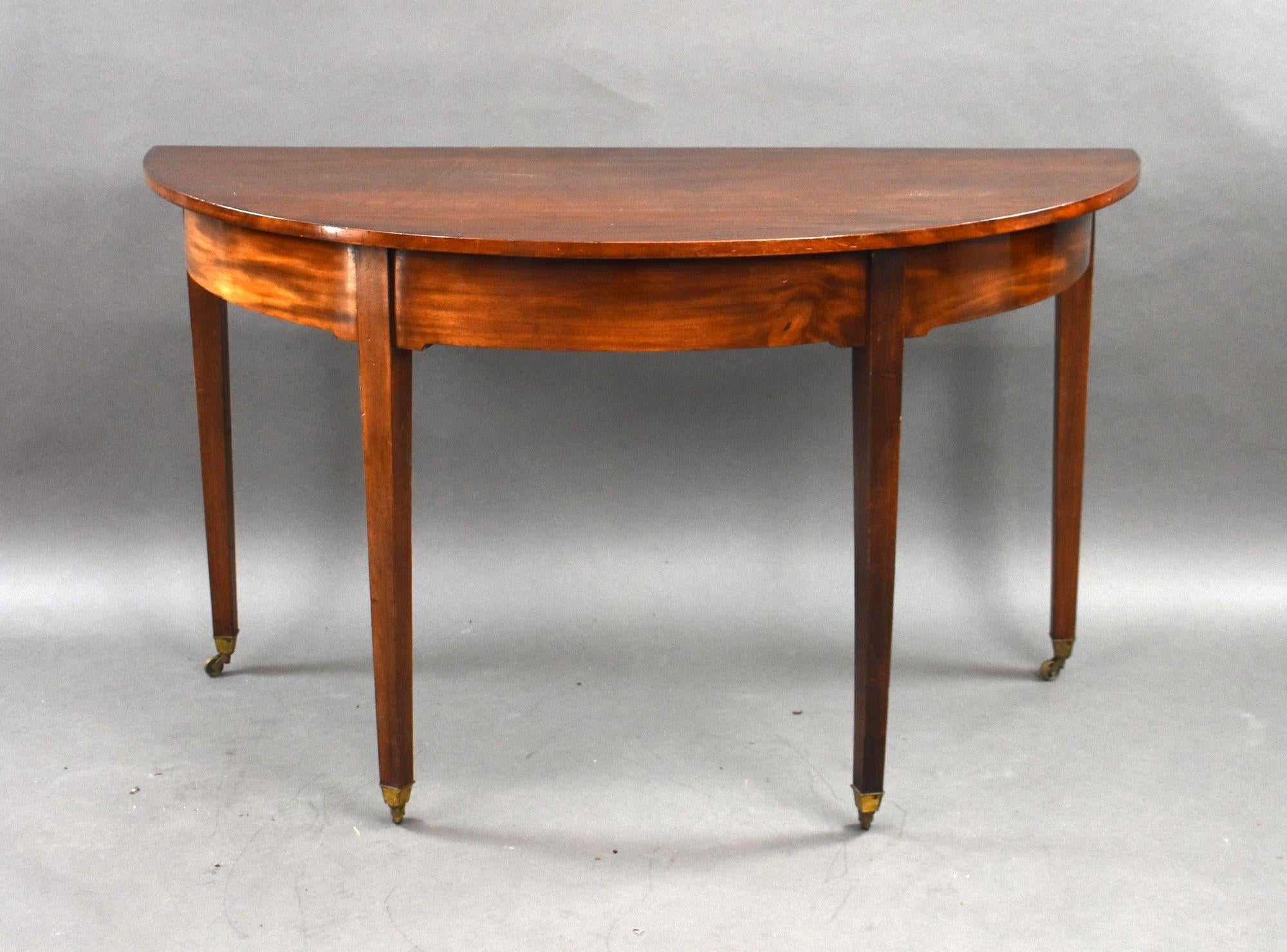 For sale is a good quality pair of George III mahogany demi lune console tables, standing on square tapered legs terminating on original castors. Both table remain in very good condition for their age.

Width: 132cm Depth: 63cm Height: 75cm