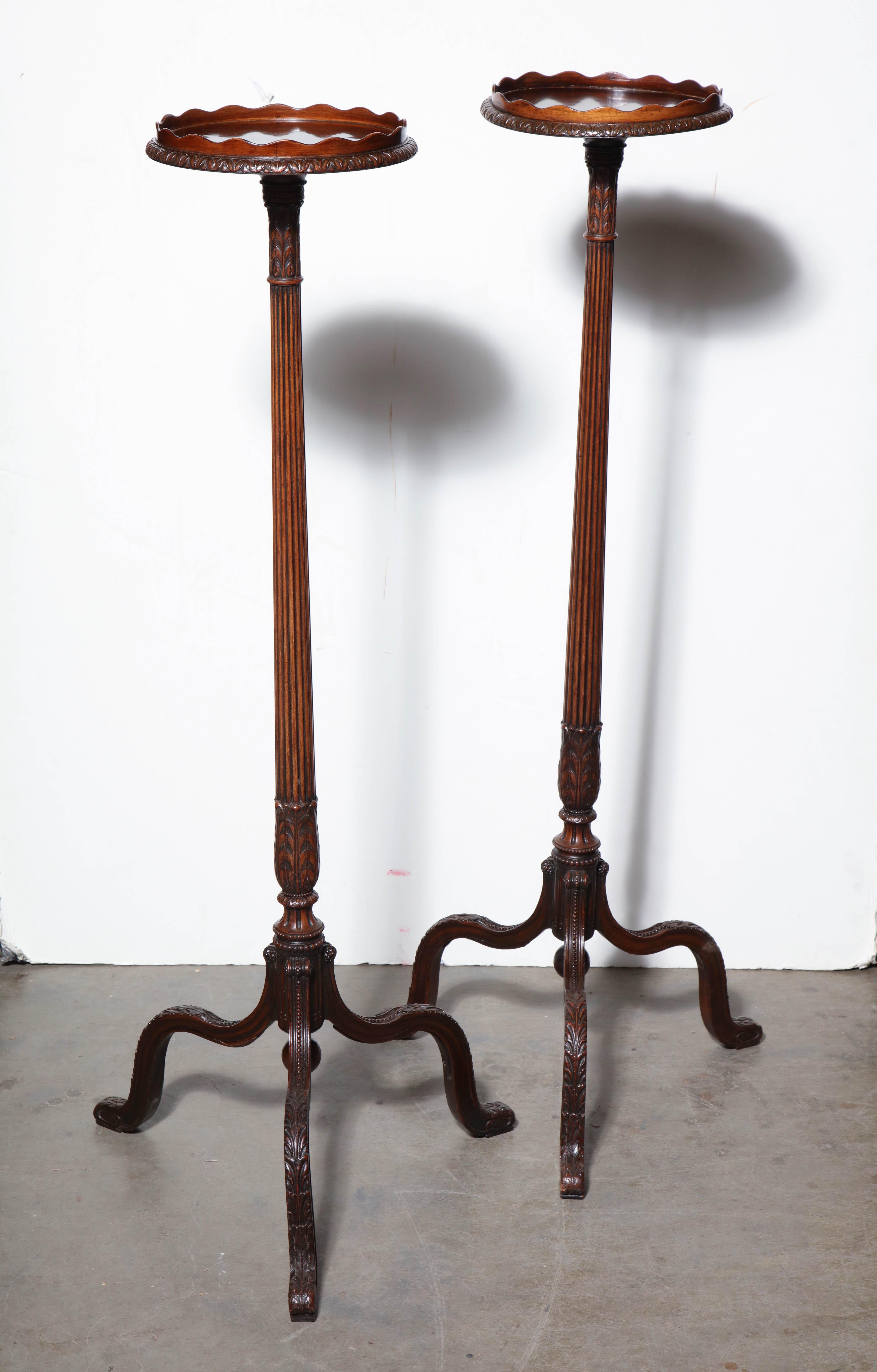 Pair of George III mahogany scroll foot pedestals with scalloped carved gallery tops, reeded supports, and cabriole legs.

The diameter of top - 11
