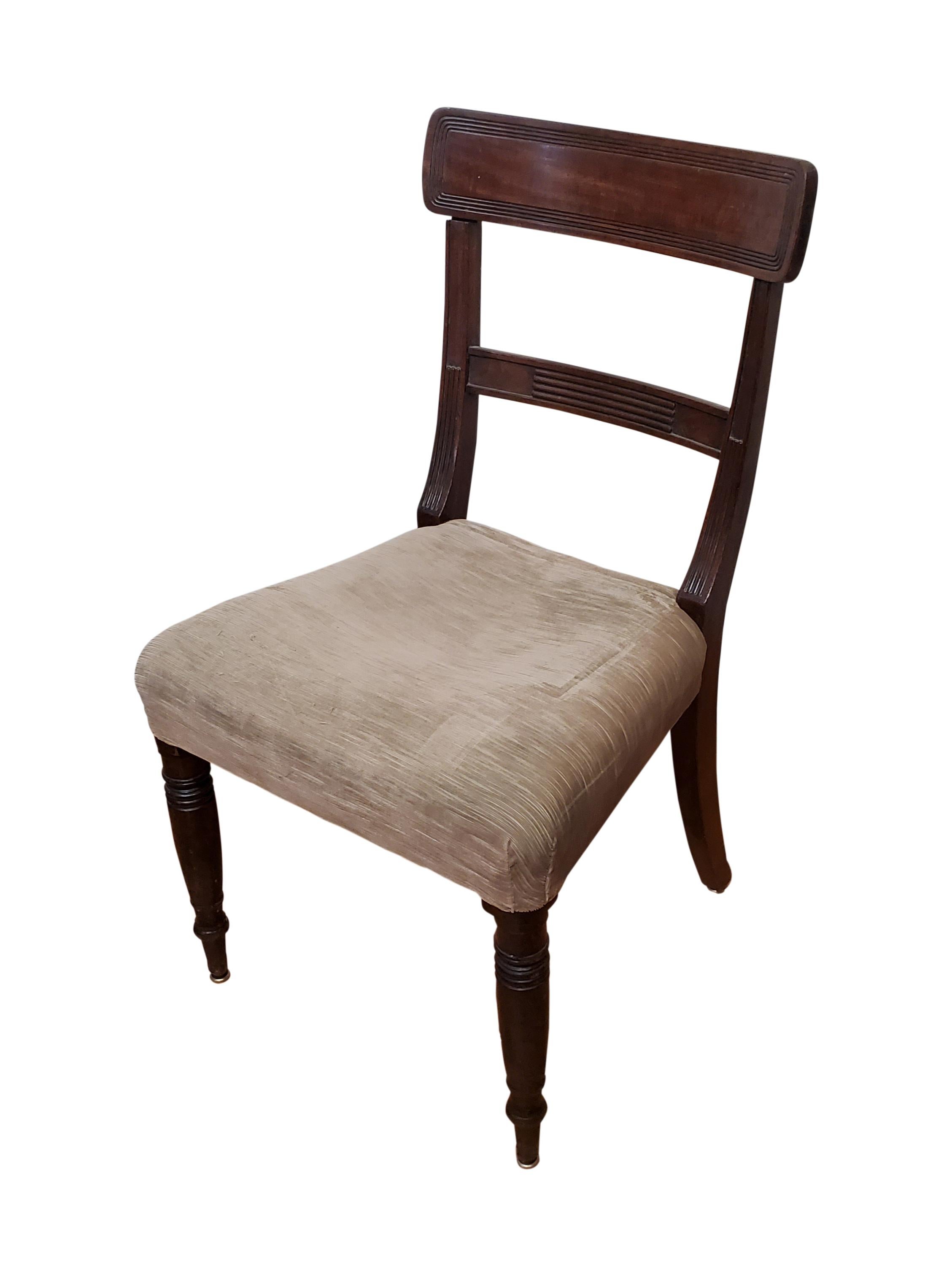 Pair of period side chairs, the seat covering is old and needs to be redone like most upholstered furniture., nice crest and turned legs, the chairs simply need to be recovered and find and new home. Made in the late Regency period, circa 1830.