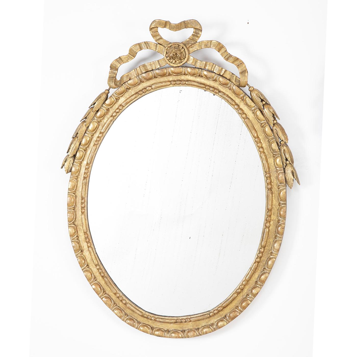A pair of English George III Adam carved giltwood oval mirrors with carved bowknot mounts and an egg and dart carved molding to the frame. 


Measures: 35