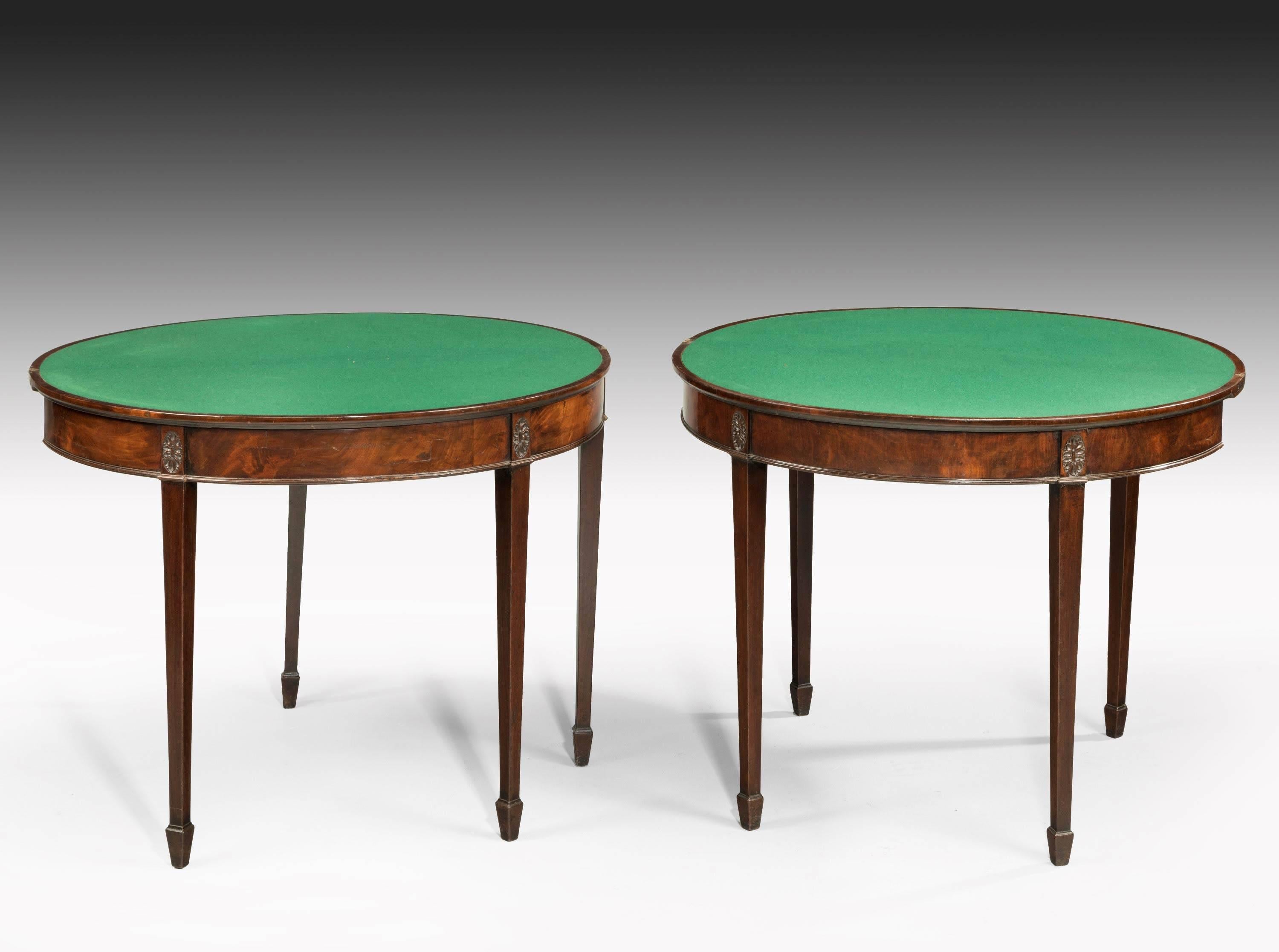 A pair of George III period mahogany tea and card tables. Showing Sheraton influence with banding in boxwood and line inlay to the edges and oval patera to the top square chamfered supports.