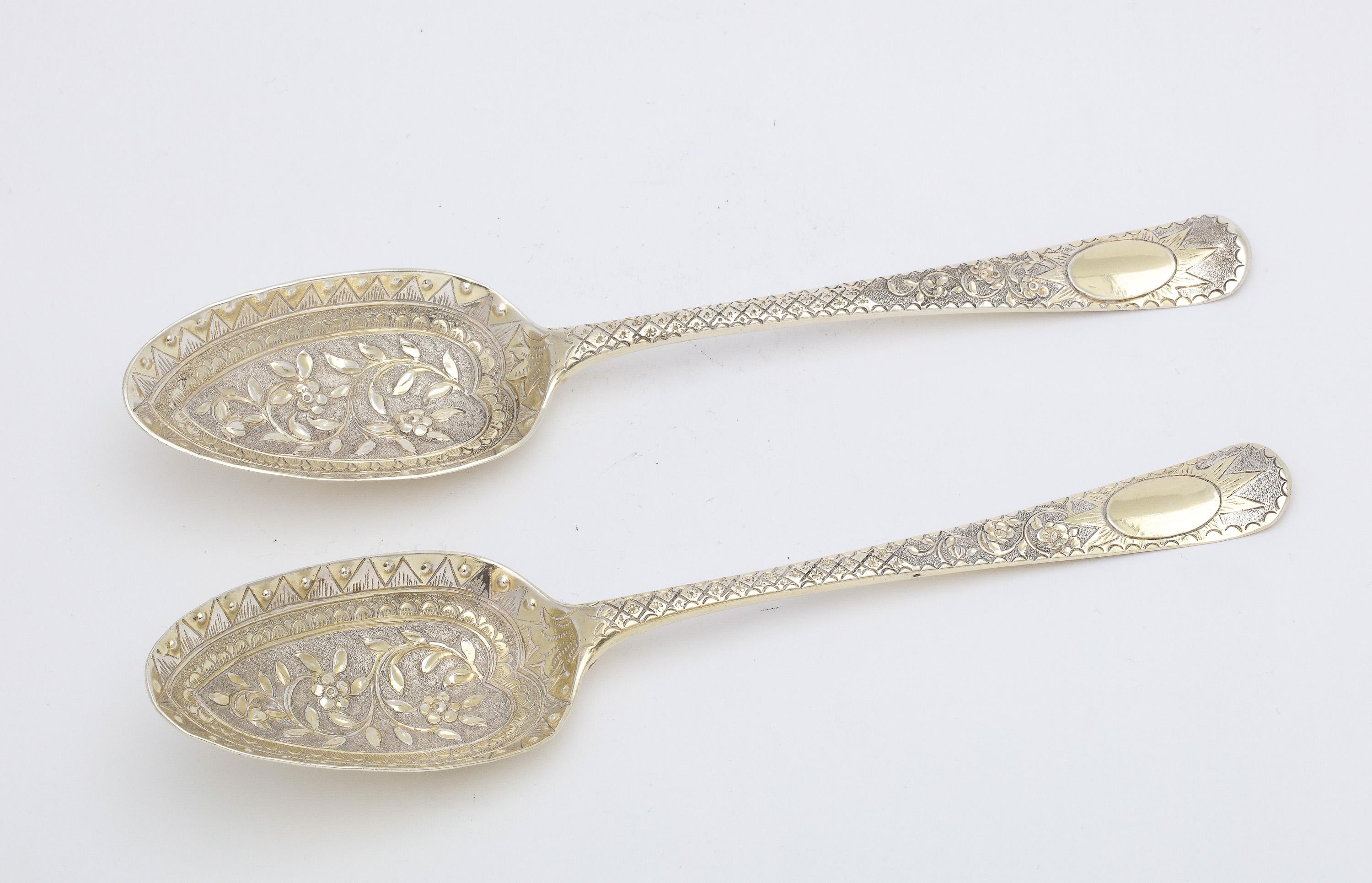 Pair of beautiful, George III Period, sterling silver gilt serving spoons, London, year-hallmarked for 1770, Thomas Evans and George Smith III - makers. Each spoon measures 8 1/4 inches long x 1 2/4 inches wide (at widest point) x 1 inch high (at