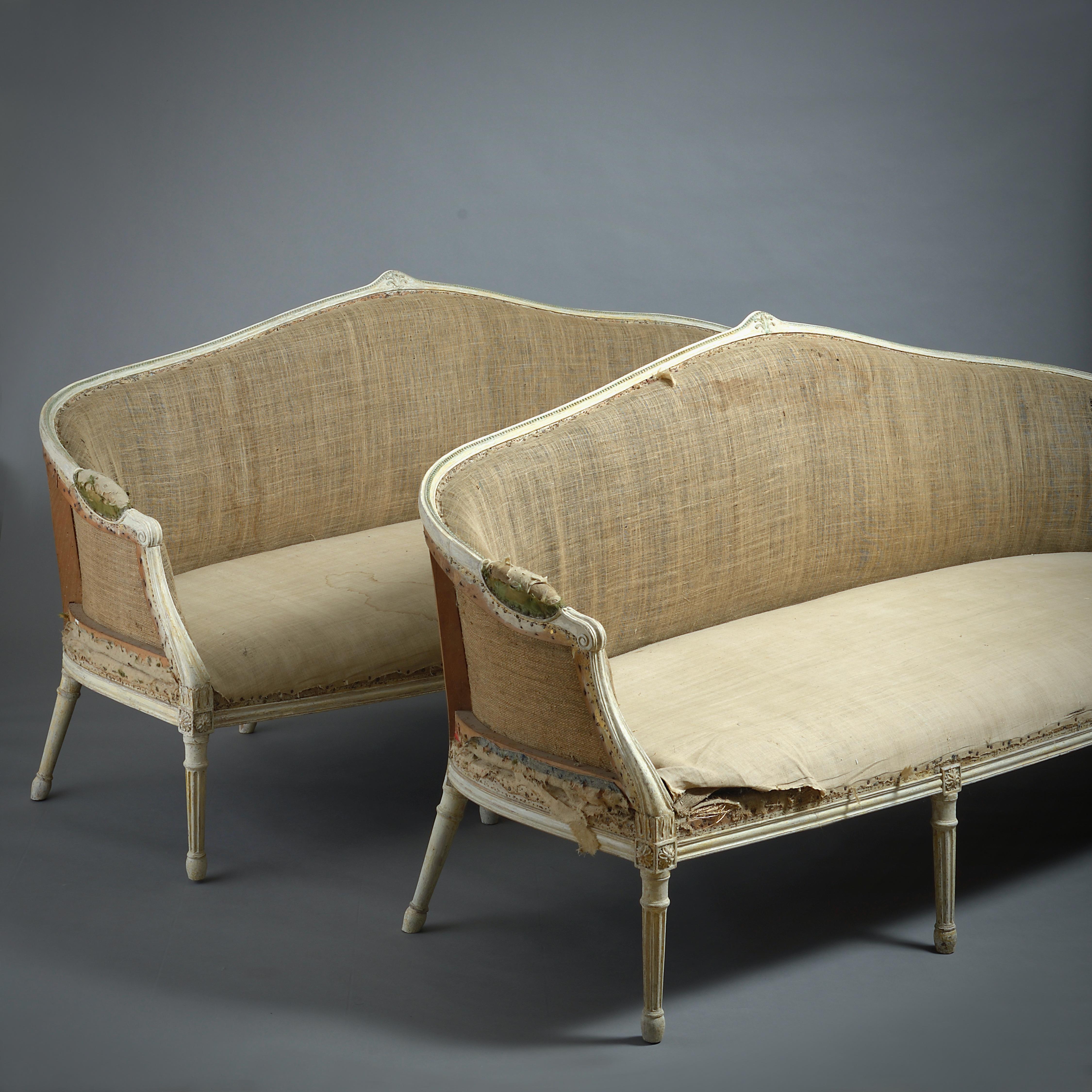 A FINE AND RARE PAIR OF GEORGE III GREEN AND WHITE PAINTED SOFAS ATTRIBUTED TO JOHN LINNELL, CIRCA 1775.

Dry-scraped back to their original paint.

PROVENANCE:
by descent in the Davenport family, Davenport House, Shropshire