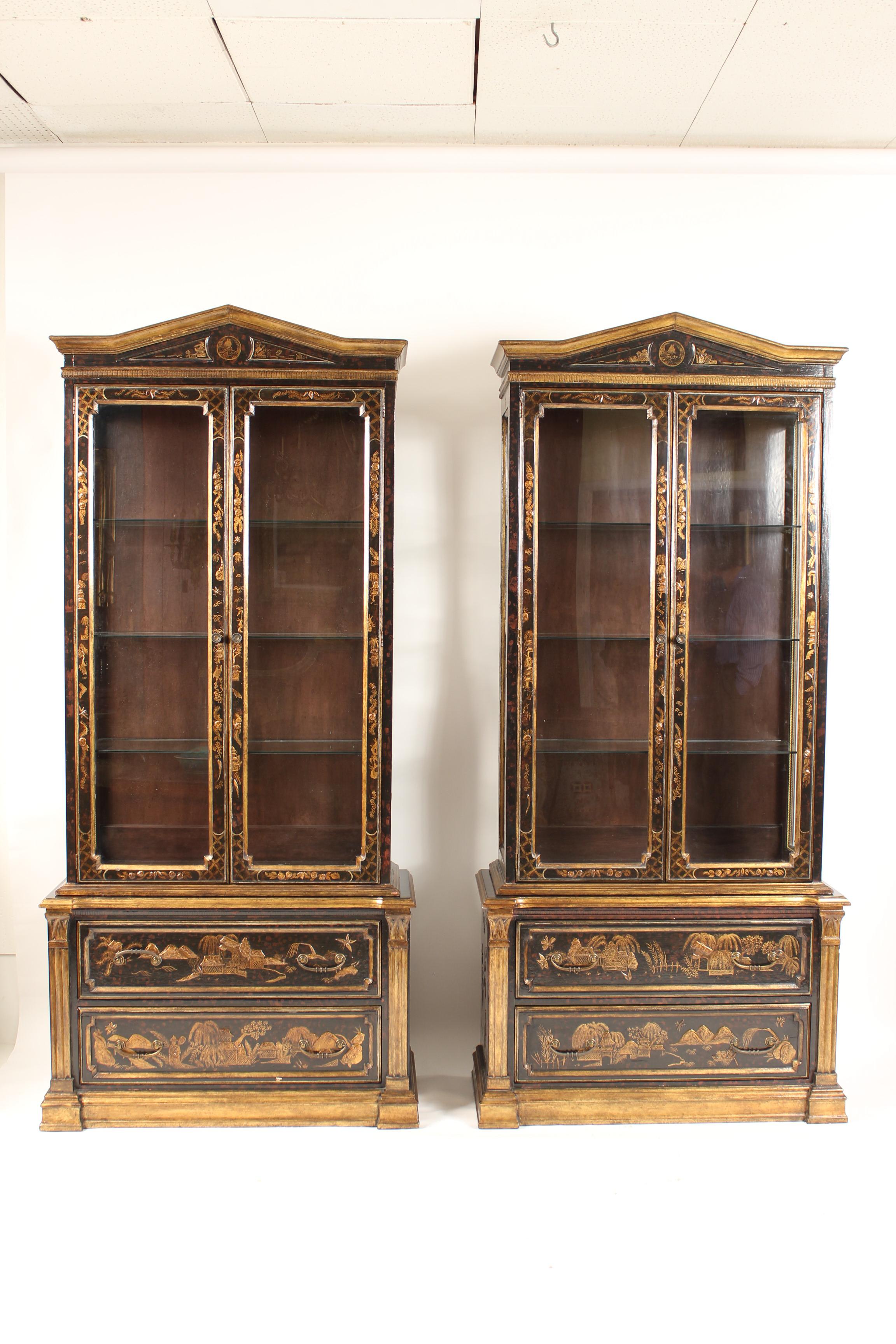 Pair of George III style chinoiserie decorated display cabinets, mid-20th century. With raised chinoiserie decorations,
interior lighting and glass shelves. The cabinets made by Davis cabinet company.