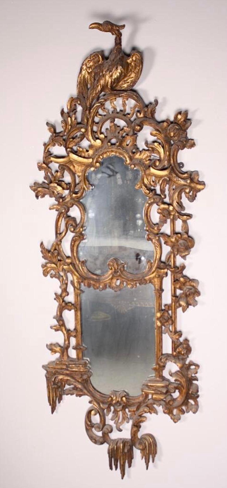 Pair of George III Style Giltwood Pier Mirrors In the manner of Thomas Chippendale.

An exceptional pair of George III style giltwood mirrors, the mirror plate within a carved and molded asymmetrical cartouche frame in the Rococo manner of Thomas