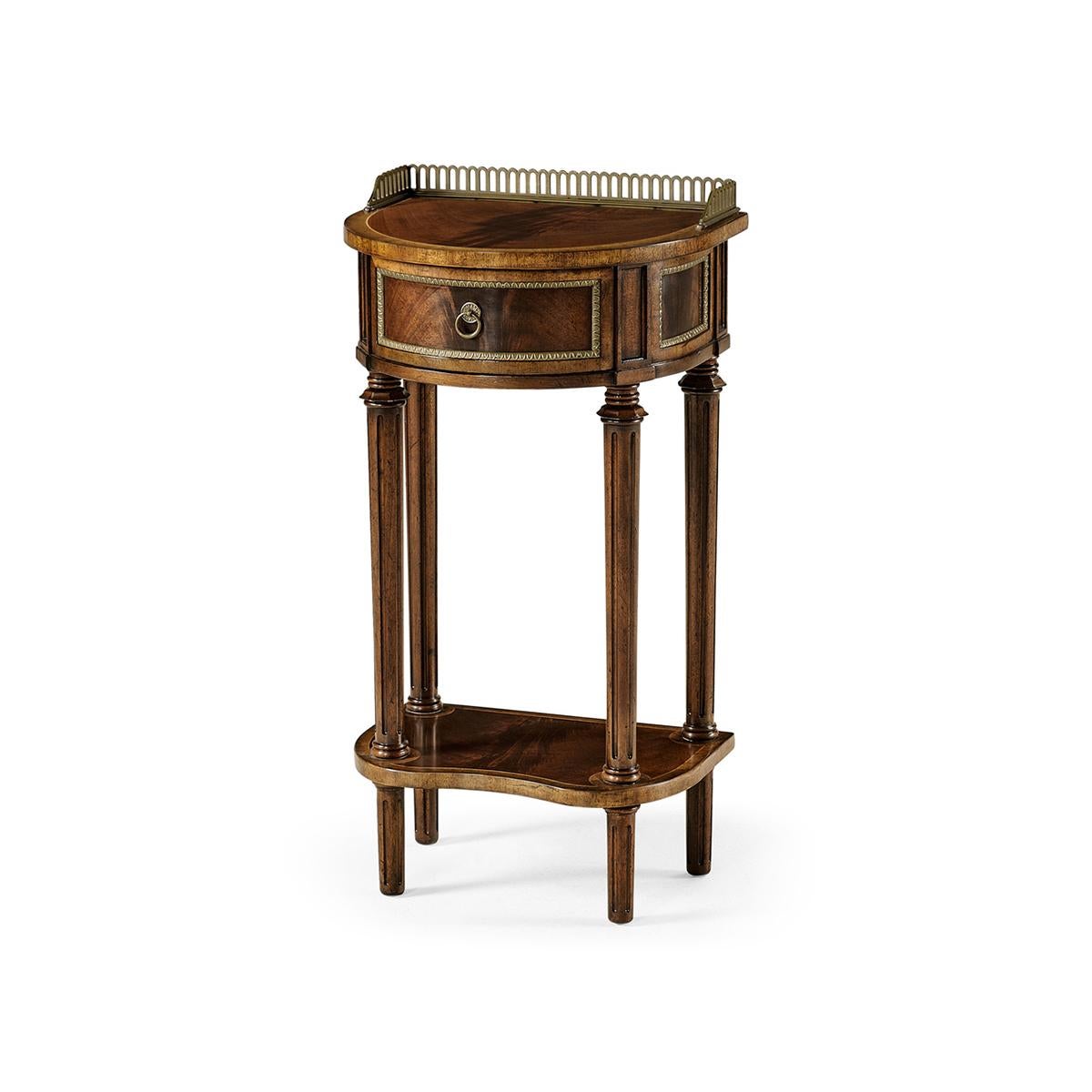 George III Style Mahogany demilune console table with a fine cast pierced antiqued brass gallery, single drawer with brass beading and a crossbanded shaped under-tier. Raised on turned, tapered, and fluted legs.

Dimensions: 16