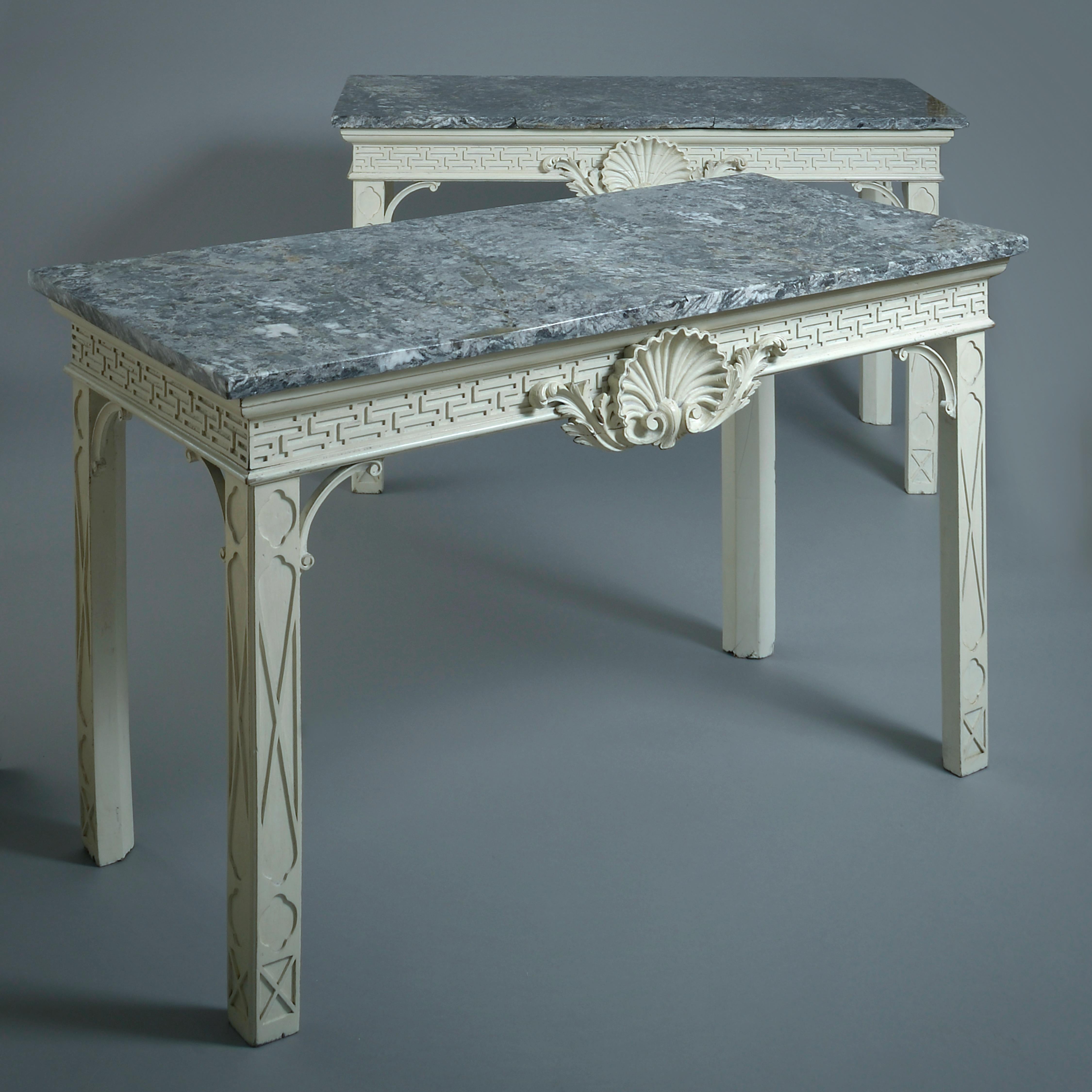 A fine pair of George II white-painted side tables, circa 1750.

Each with its original grey marble top. Redecorated following traces of original stone white paint.