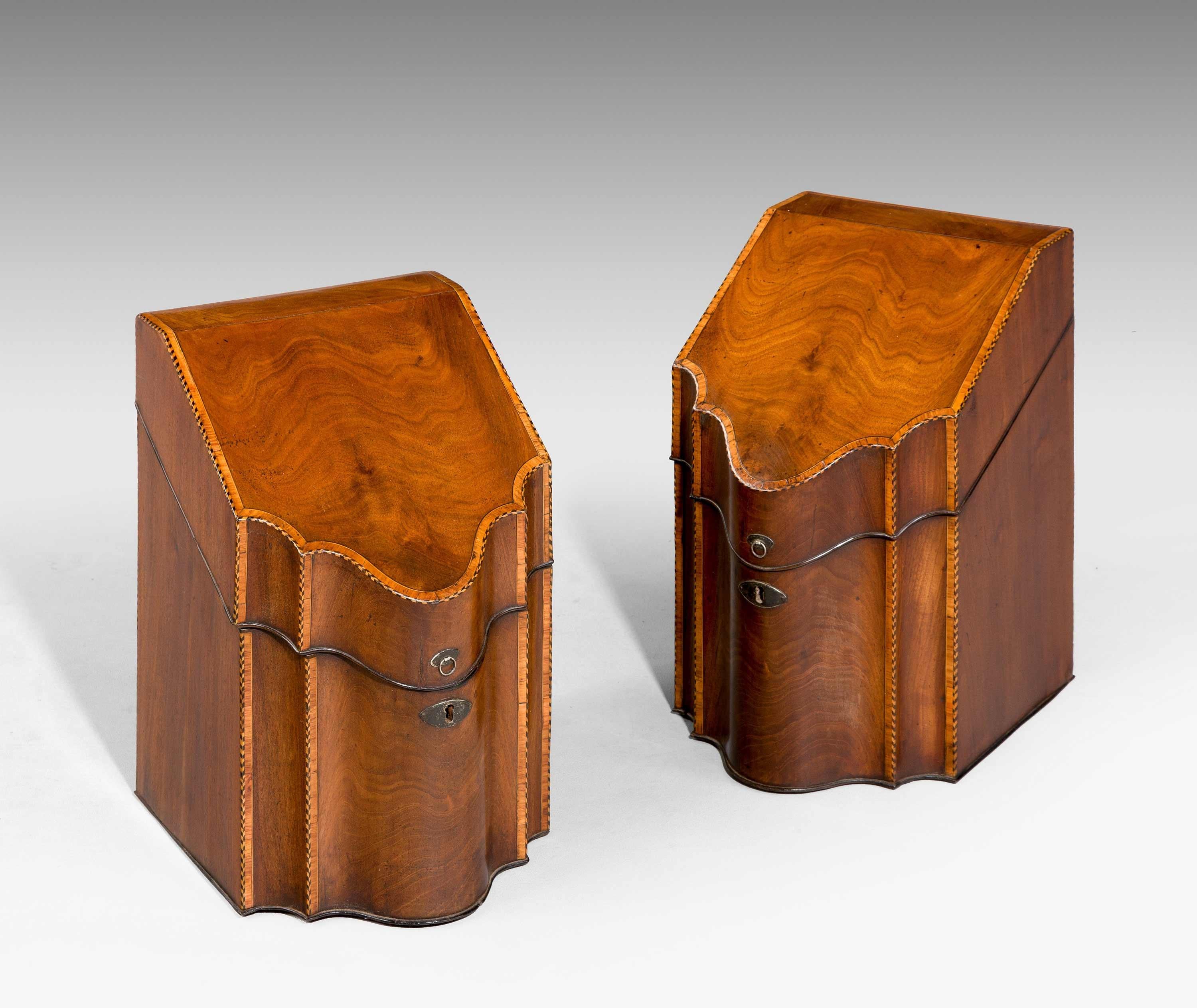 A very good pair of George III period serpentine mahogany knife boxes with kingwood crossbanding and fine chequered ebony and boxwood line edge. Excellent figured timbers, well fitted interior and fine old Sheffield plated escutcheon and ring