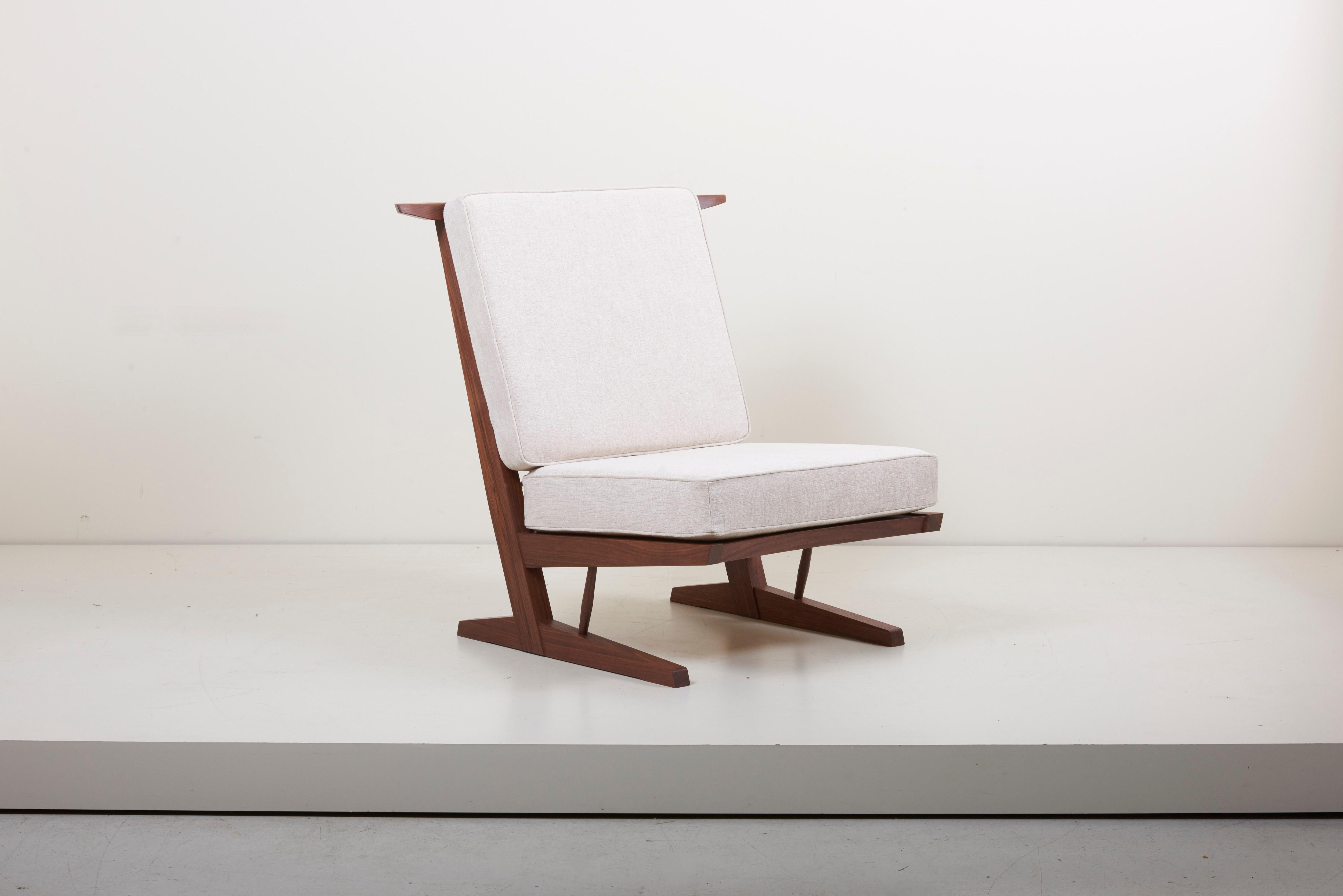 Pair of Conoid lounge chairs in American black walnut with hickory spindles by Mira Nakashima based on a design by George Nakashima. Photo is just an example. Please consider the production lead time of around 18 months. 

