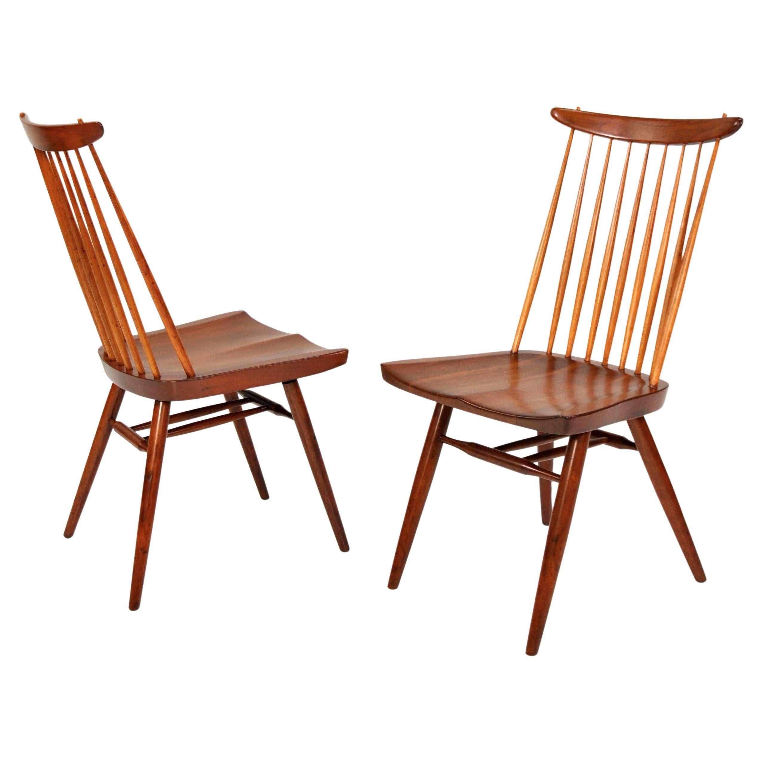 A pair of rare and early model 271 or New Chairs, the iconic Windsor spindle back chairs reimagined by Japanese-American Master Woodworker, George Nakashima in 1956. East Indian Laurel wood in the original Sundra finish with hickory spindles.
