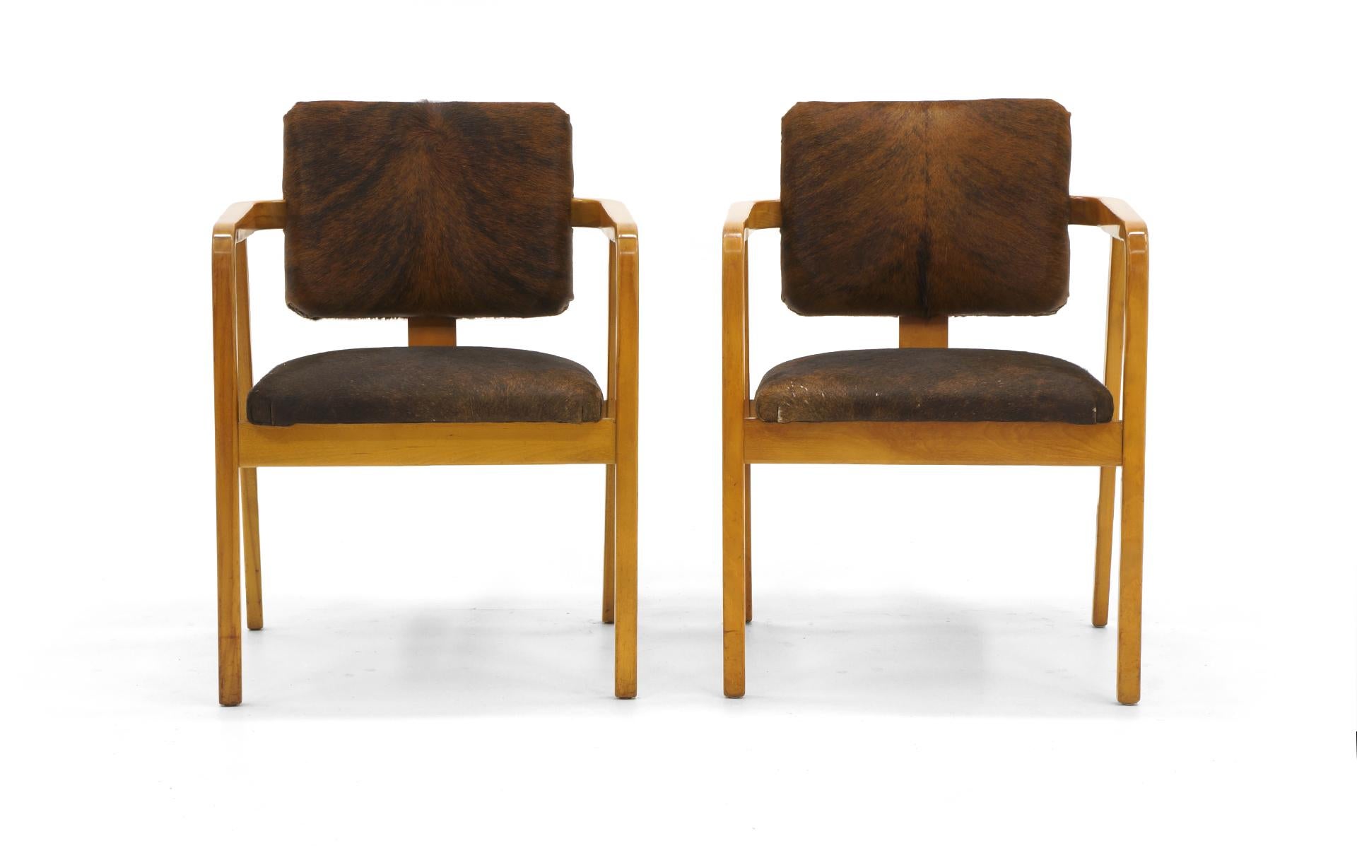Pair of George Nelson for Herman Miller armchairs with new cowhide upholstery. Great for any modern environment besides the obvious modern cabin or rustic setting.