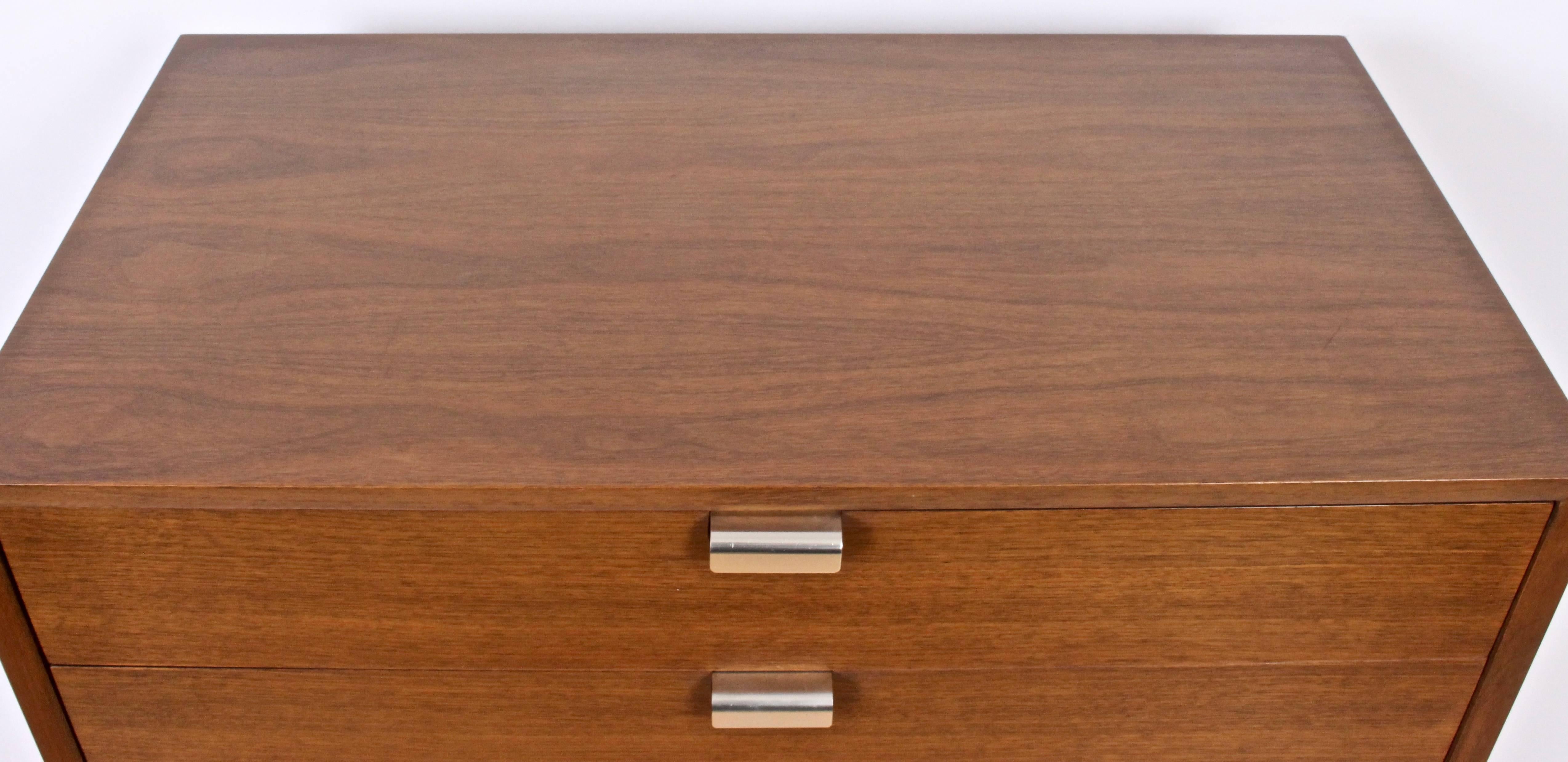 Pair of 1950s George Nelson for Herman Miller four-drawer Walnut Nightstands. With Herman Miller marked Brushed Aluminium J pulls to top drawers. Top drawers with six divided compartments, bottom drawers with two dividers. Drawers slide easily. With