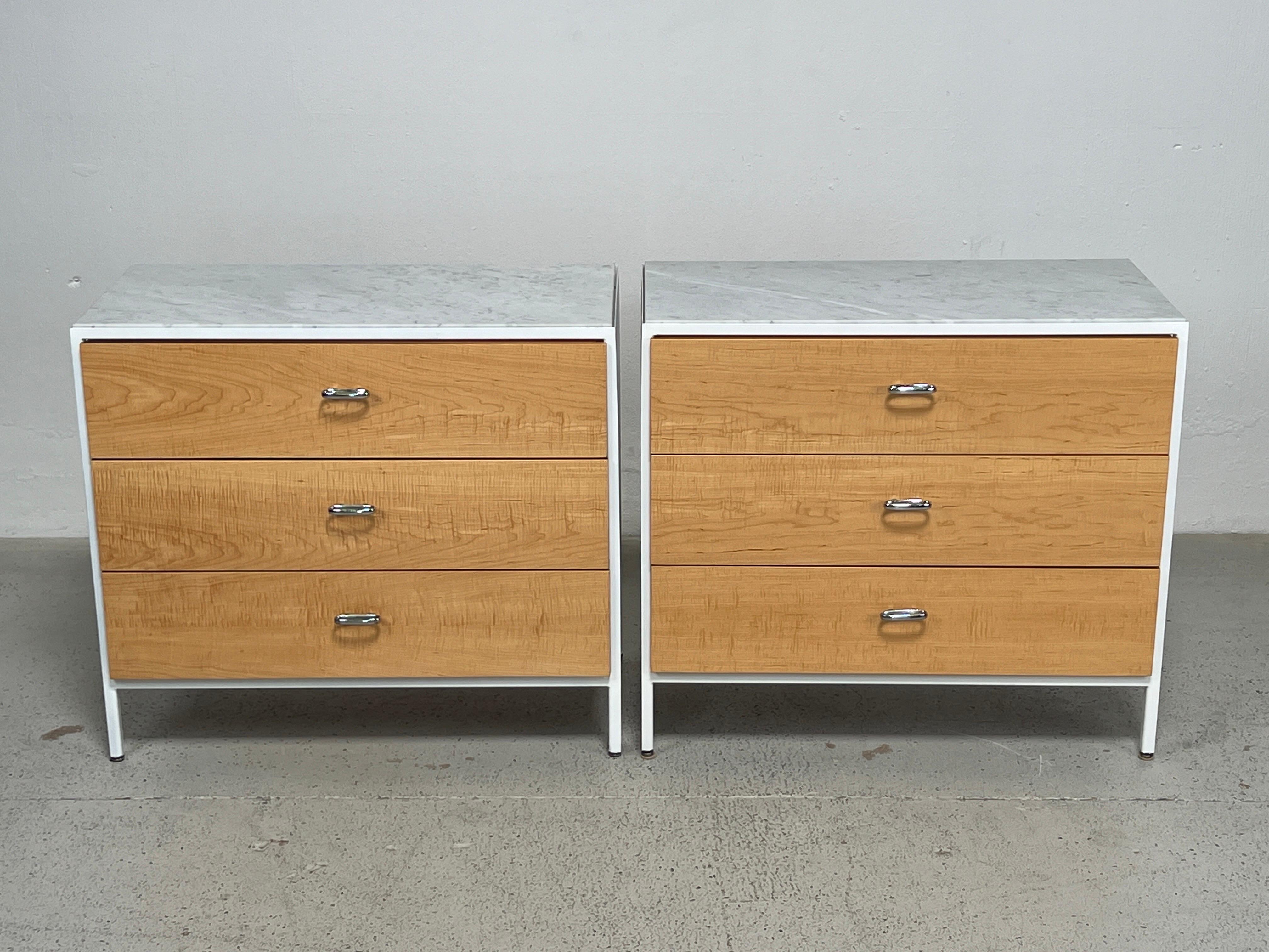 A beautiful pair of steel frame cabinets designed by George Nelson for Herman Miller. All cabinets restored with maple drawer fronts and marble tops. Third matching cabinet available separately. 