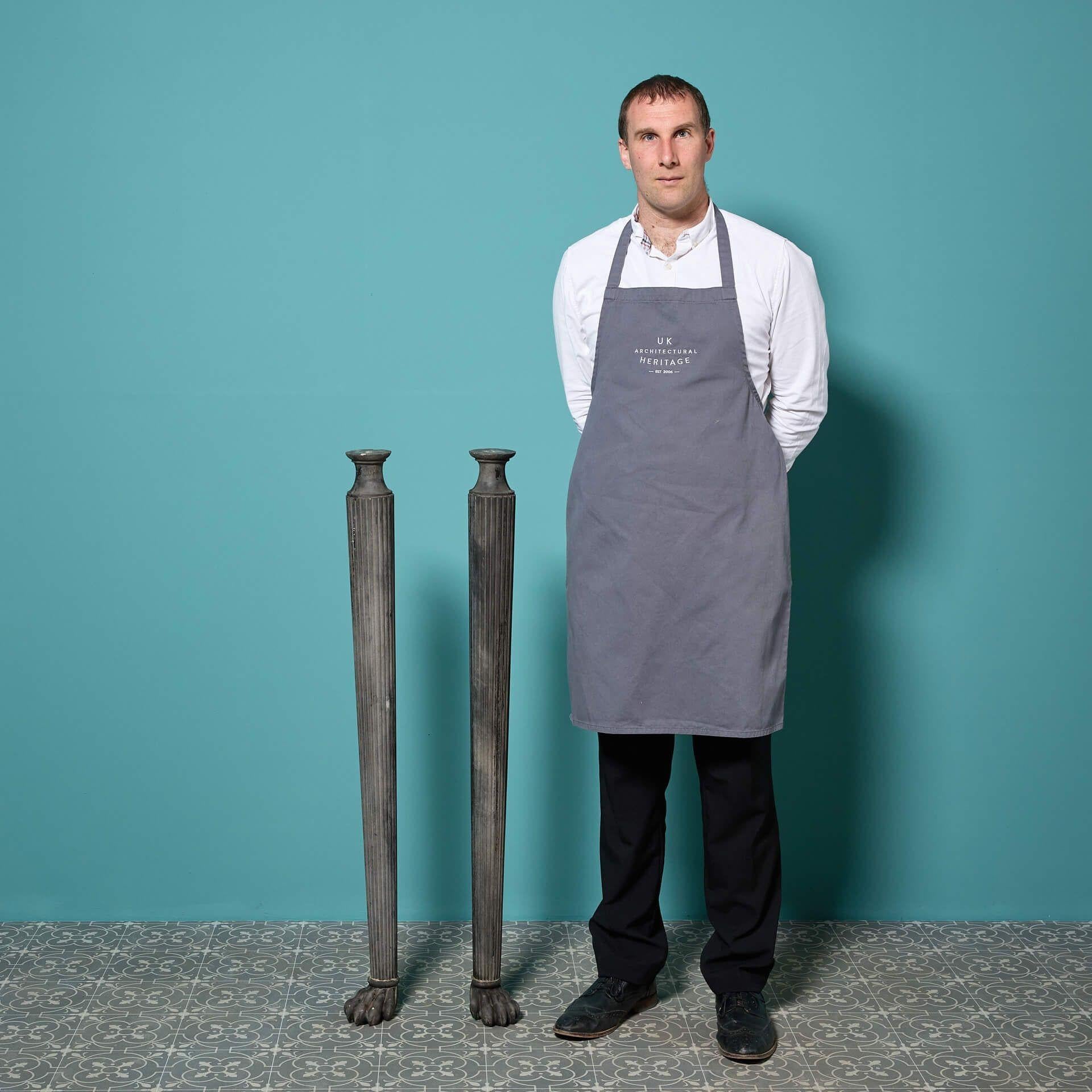 A handsome matching pair of Georgian hand carved slate freestanding columns, circa 1800. 

Styled with a fluting design to the columns that stand upon stylised lion paws, their scale, appealing dark grey slate finish makes each piece a stunning