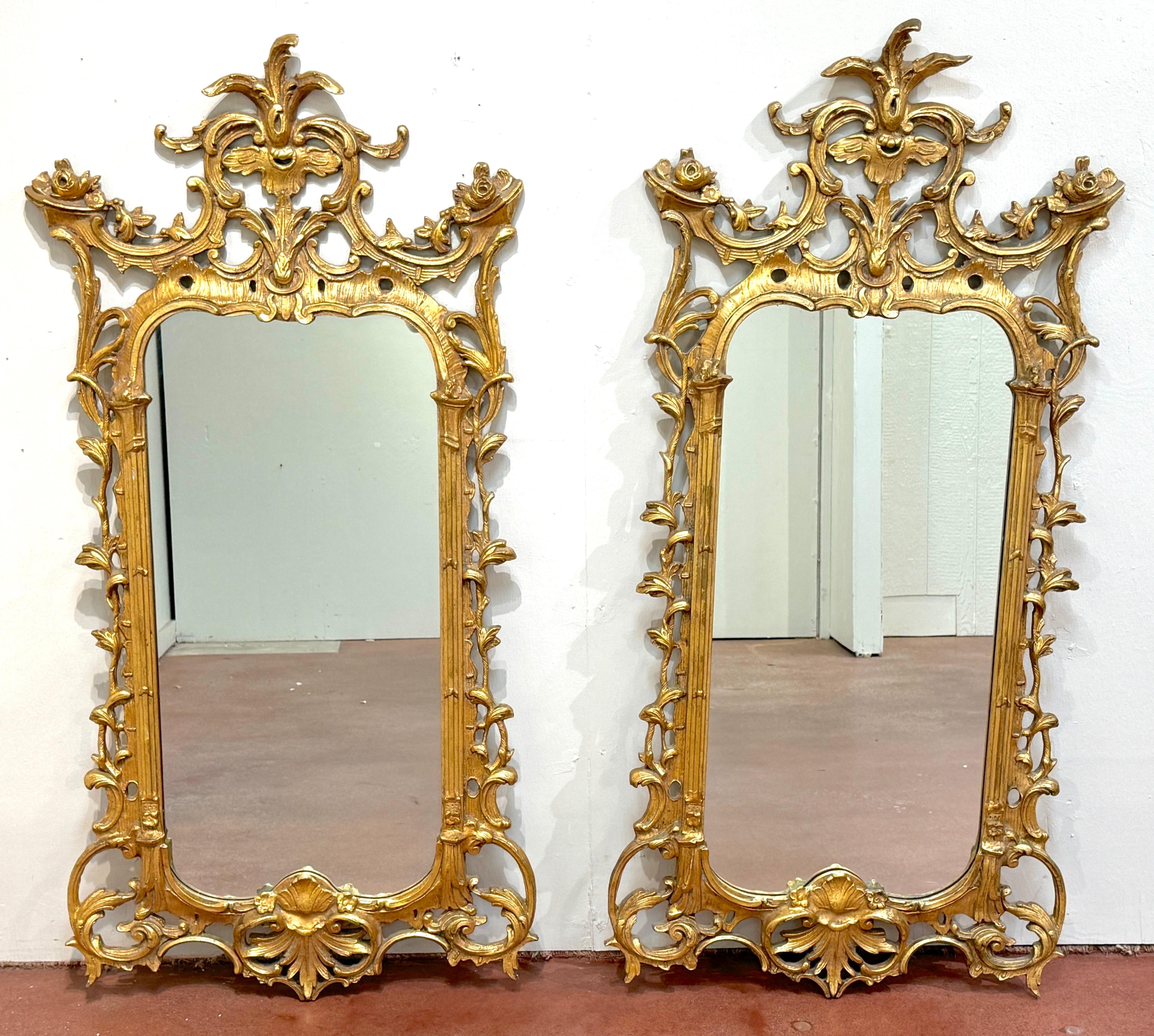Pair of Georgian Chinoiserie Style Carved Giltwood Mirrors 
Italy, circa 1950s

An exquisite pair of Georgian Chinoiserie Style Carved Giltwood Mirrors from Italy, circa 1950s. Each mirror, inspired by the fluid elegance of Georgian design and