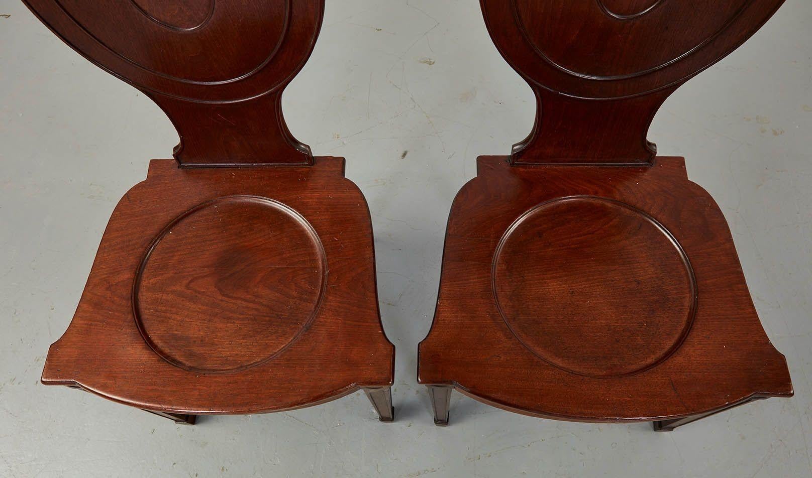Mahogany Pair of Georgian Chippendale Hall Chairs For Sale