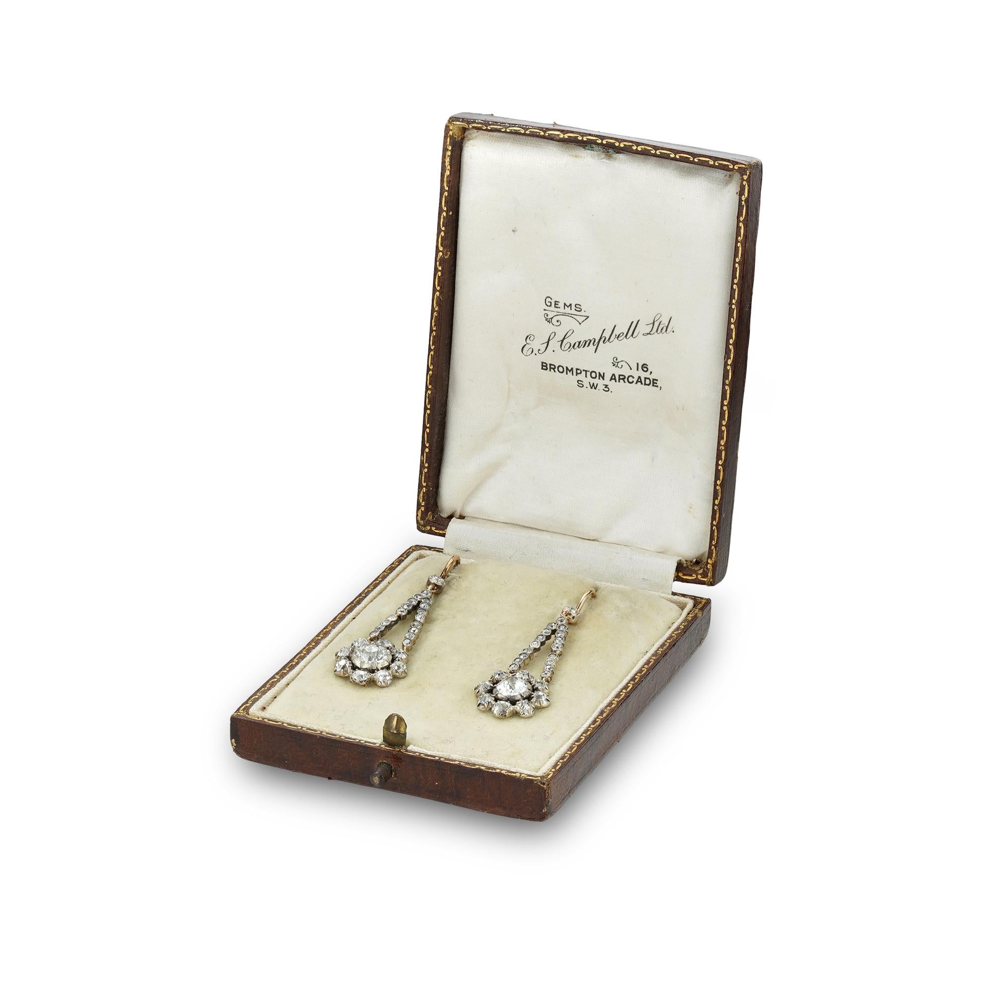 A pair of Georgian diamond pendant earrings, each with a central old-cut diamond weighing approximately 0.7 carats, surrounded by an old-cut diamond cluster, each cluster suspended from a flexible run of smaller old-cut diamonds, all to a