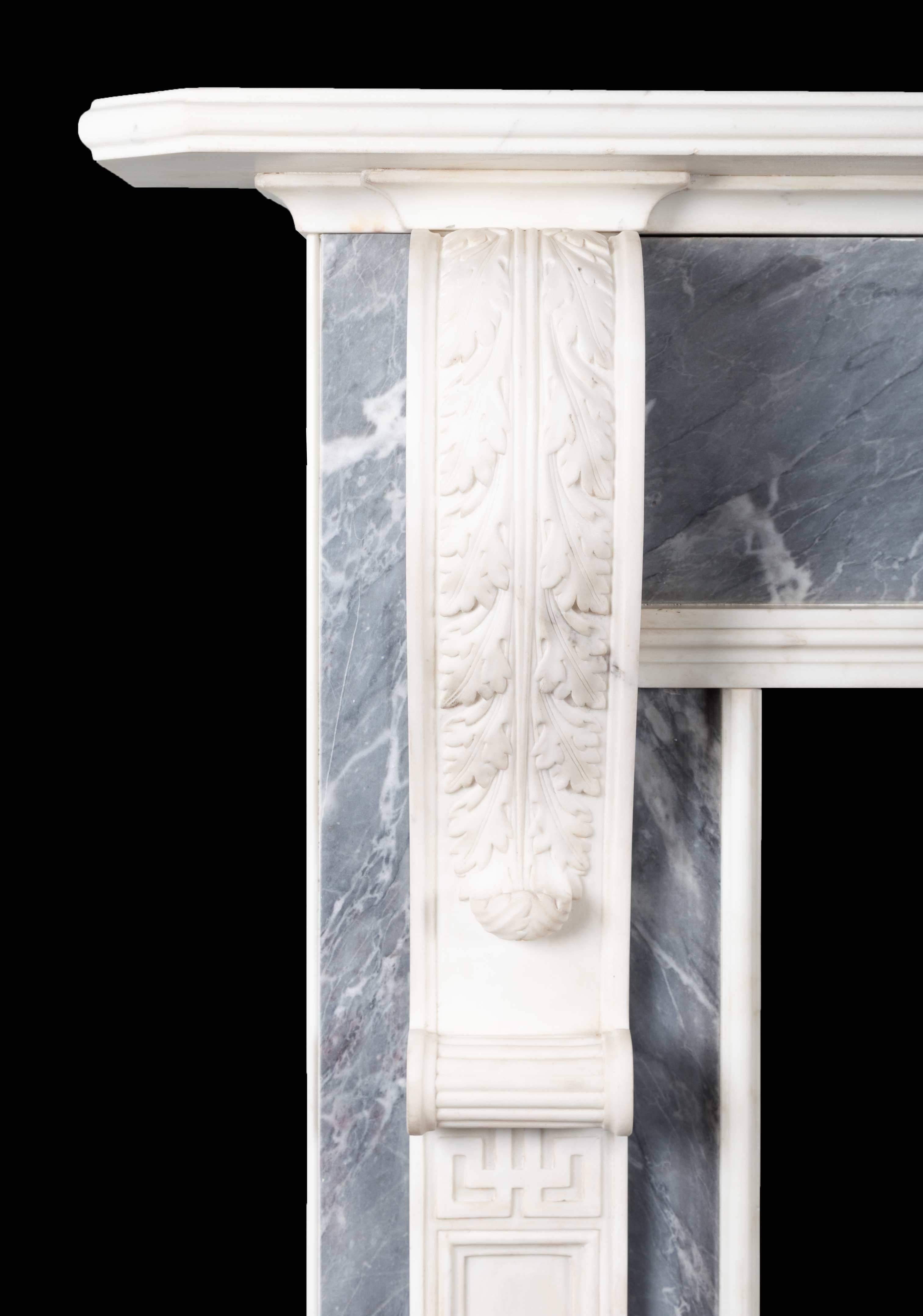 A pair of antique dove grey and white statuary marble fireplaces from the late Gerogian period. The long elegant acanthus carved corbels with recessed pilasters below, support a moulded and chamfered edge mantelpiece. The exquisitely carved centre
