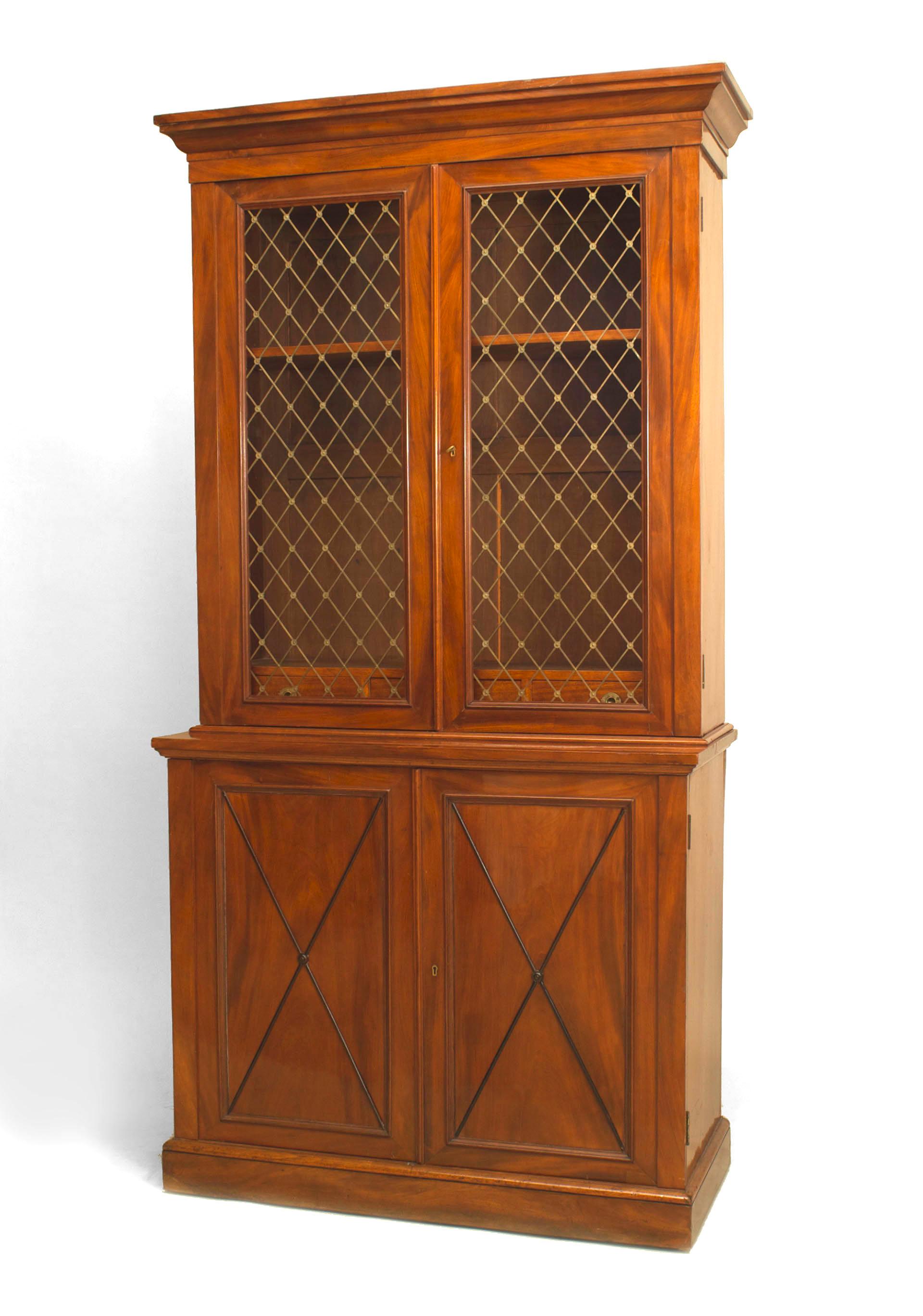 Pair of nineteenth century English mahogany bookcases, each featuring two upper glass doors decorated with brass lattices and two lower doors decorated with an ebonized 