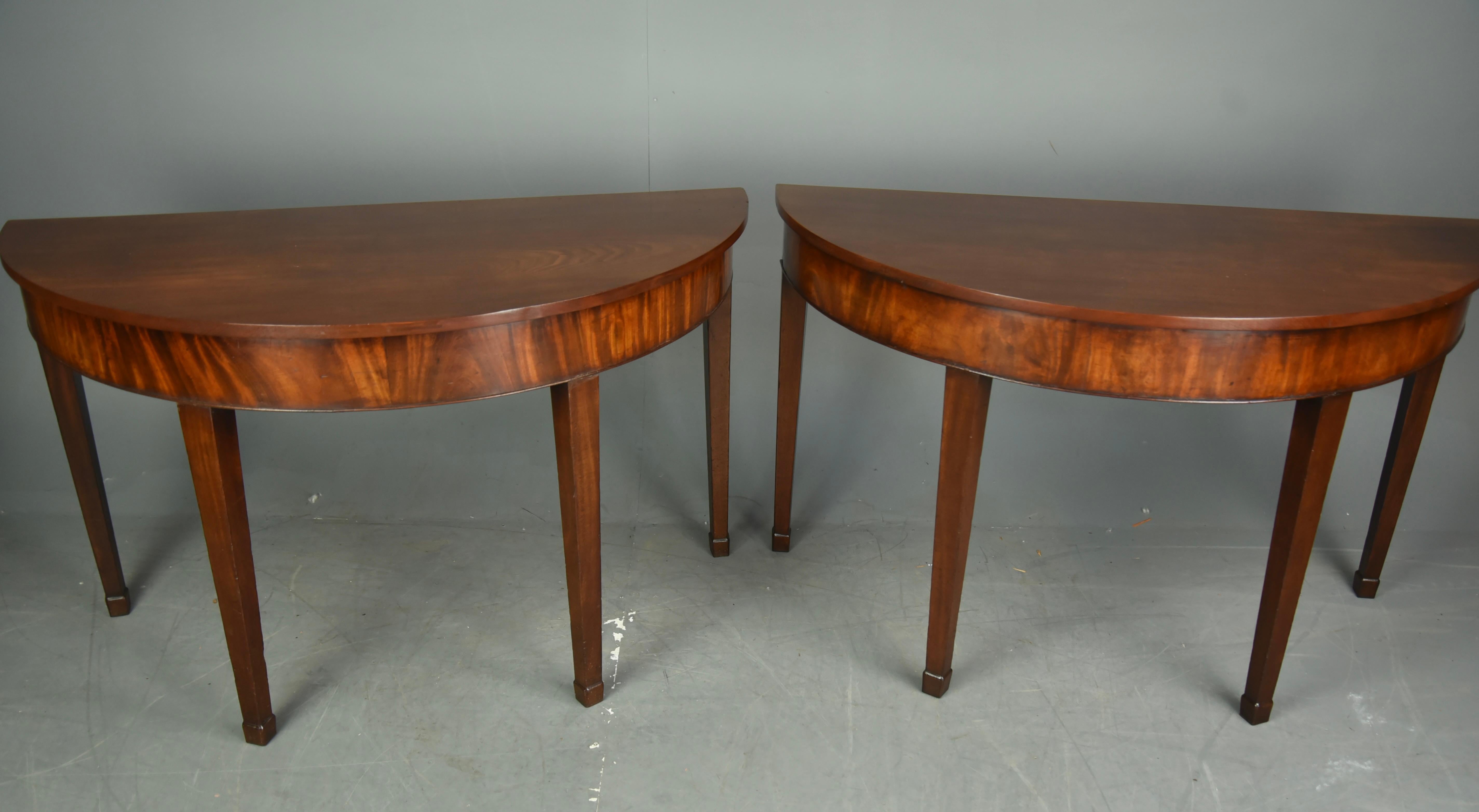 fine pair of early Georgian mahogany demilune console tables, circa 1720.
The table have very fine quality solid mahogany tops that have a great rich colour and grain formed from a single plank.
They each stand on four solid mahogany tapered legs