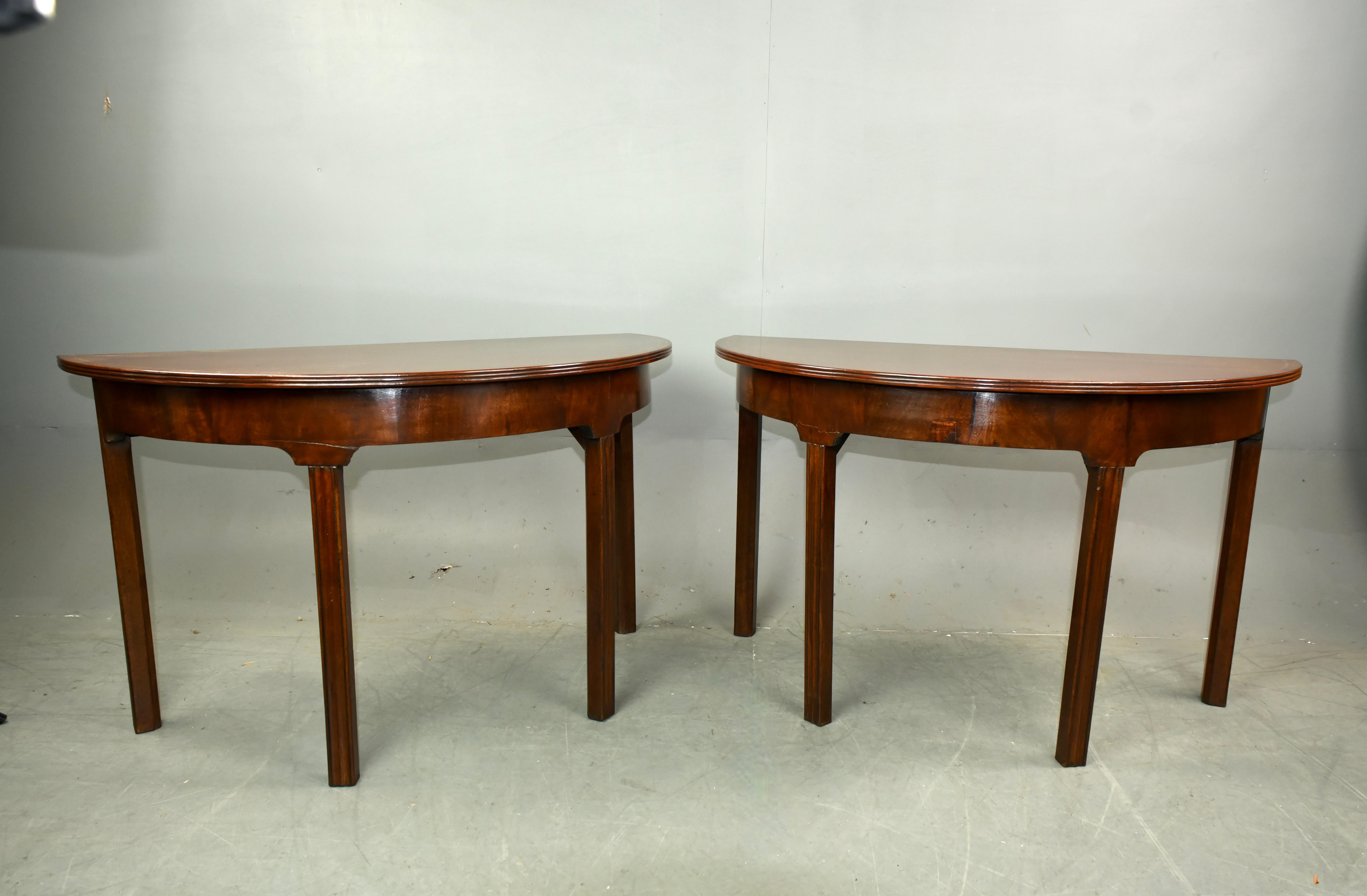 Fine pair of Georgian mahogany Demi lune console tables circa 1760

The tables have great proportions with fine figured solid mahogany tops with an inlay banding .
They stand on reeded tapered legs and are very sturdy .
The tables are a great rich