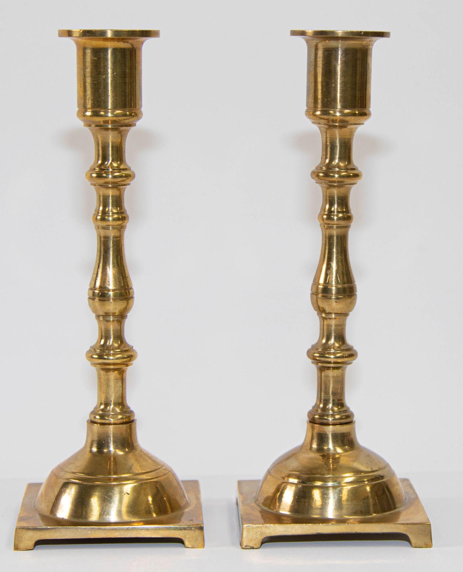 Pair of Georgian polished brass candlesticks having a shaped column raised on a square footed base.
Pair of Georgian Antique Brass Candlesticks A more unusual fine pair of English solid brass candle holder.
20th century Pair of English antique