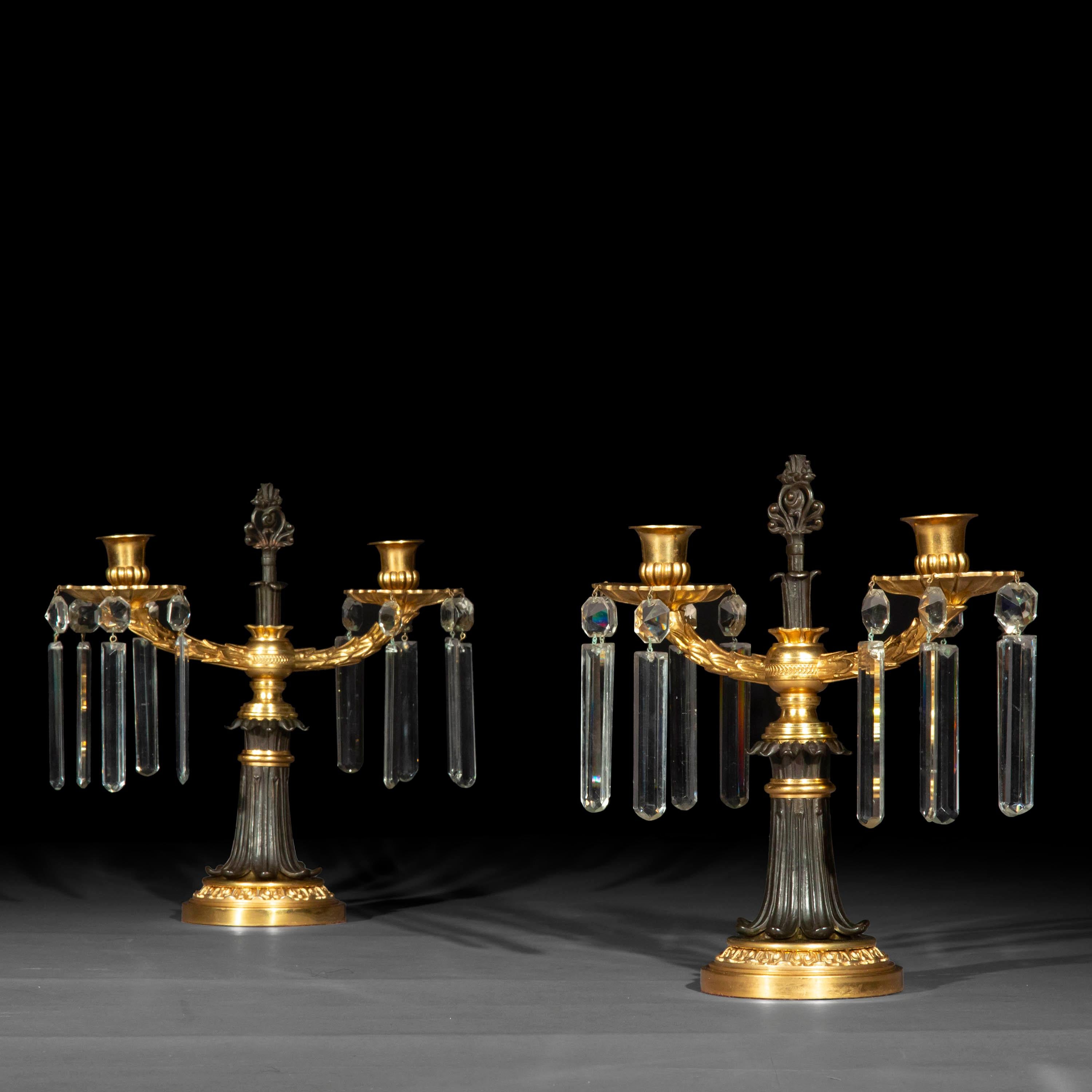 A fine pair of Regency period gilded and patinated bronze candelabra or candlesticks.

English, circa 1810.


Why we like them
Exquisite, late neoclassical design; beautiful contrast of the gilded  and patinated bronze. A splendid accent in a