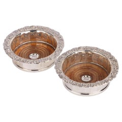 pair of Georgian silver-mounted oak wine bottle coasters